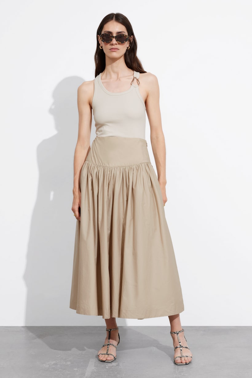 & Other Stories beige A-line midi skirt with a gently pleated silhouette.