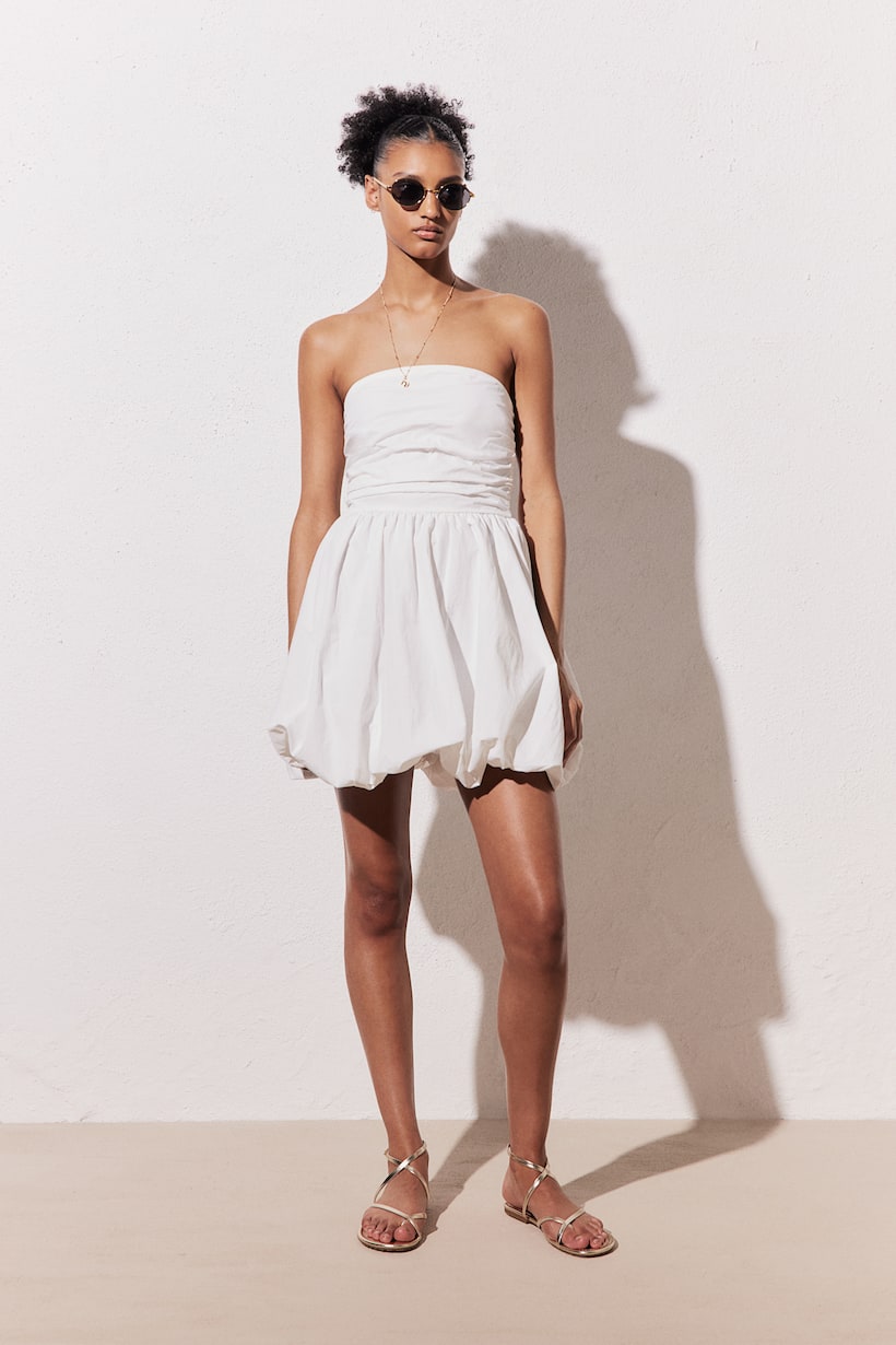 H&M  white bubble hem bandeau dress. Short bandeau dress in woven fabric with gathered side seams and a smocked section at the back. Gathered seam at the waist and a voluminous skirt with a bubble hem for a puffy silhouette. Lined.

