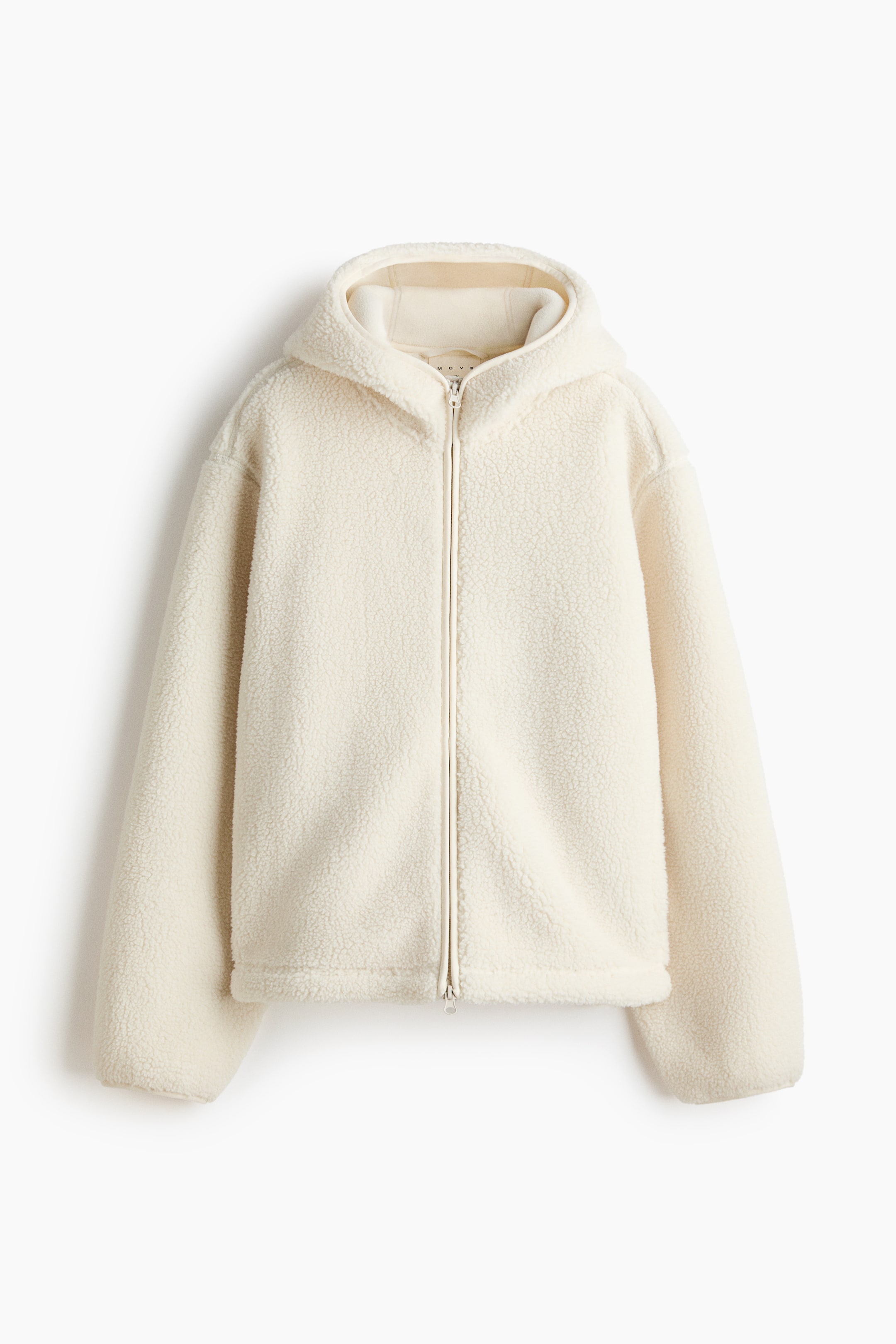 Ver imagen más grande: Se muestra vista de frente una sudadera con capucha de forro polar de color crema. Presenta un cierre con cremallera de largo completo y muestra un material sherpa suave y texturizado en el cuerpo, la capucha y las mangas largas.