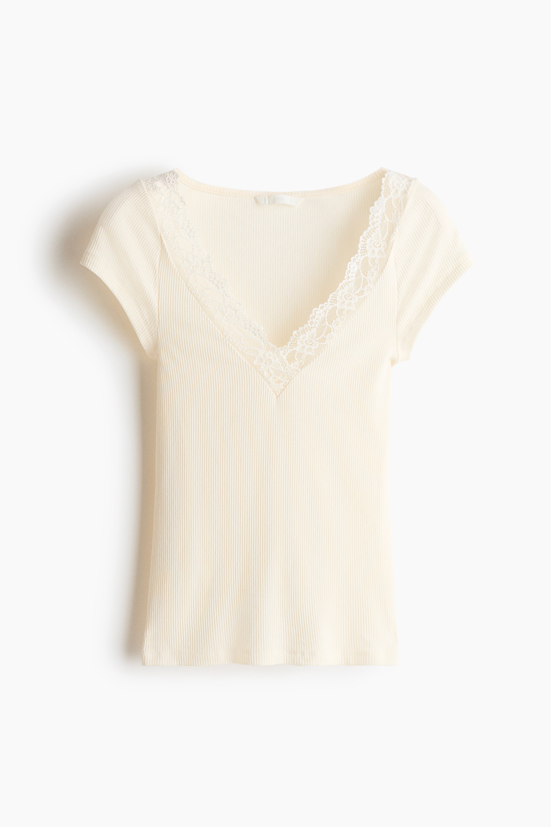 View larger image: The fitted top is crafted from cream ribbed jersey, showcasing a lace-trimmed V-neckline and short sleeves with a raglan cut at the front.