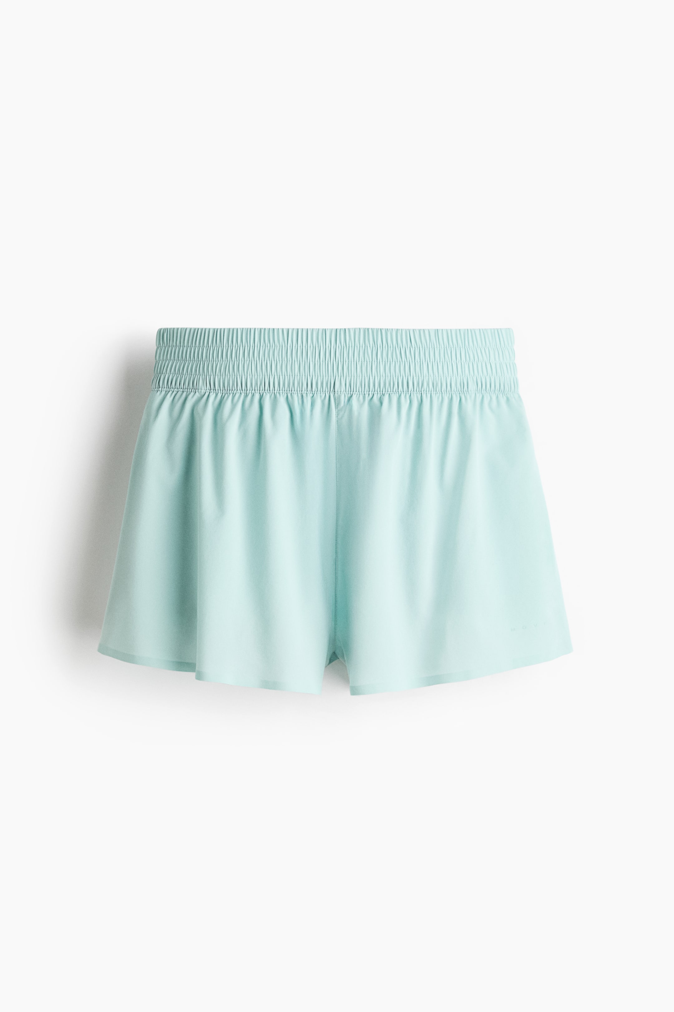 Ver imagen más grande: Los shorts azul aguamarina presentan una cintura elástica fruncida y perneras de largo corto. En el dobladillo se aprecia una capa interior sutil y ligeramente translúcida.