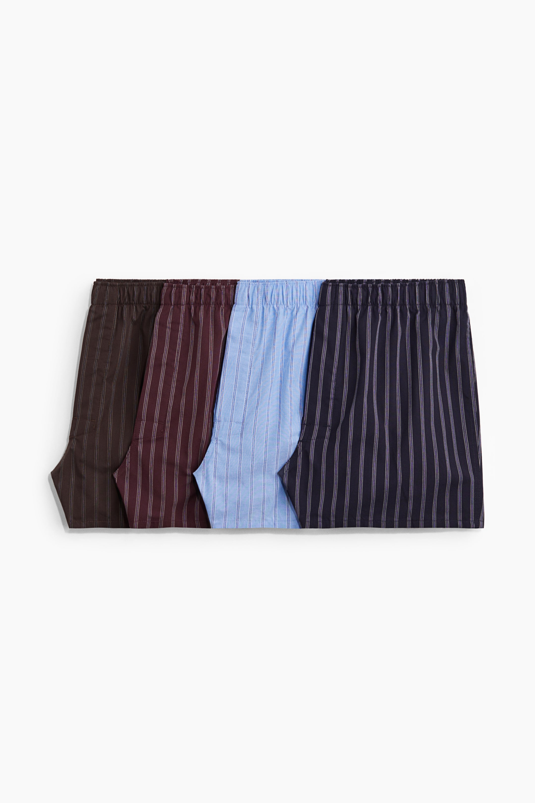 View larger image: Four pairs of vertically striped boxer shorts are lying flat, showing their elasticated waists. The shorts are in brown, burgundy, light blue, and navy colours.