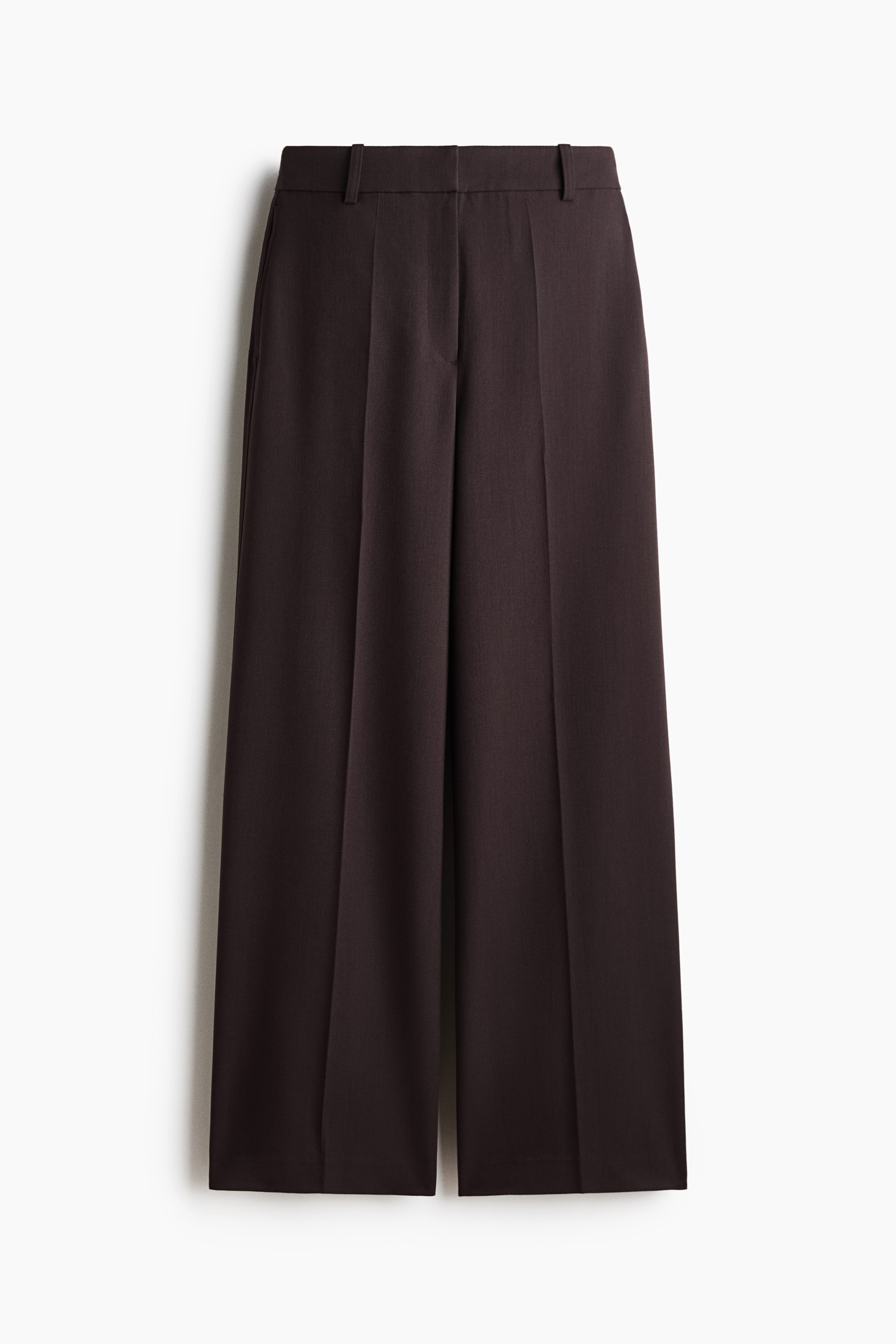 View larger image: Tailored trousers in a dark brown woven fabric feature a high waist with a zip fly and discreet side pockets. The front-facing garment showcases wide legs with prominent creases running down the front.