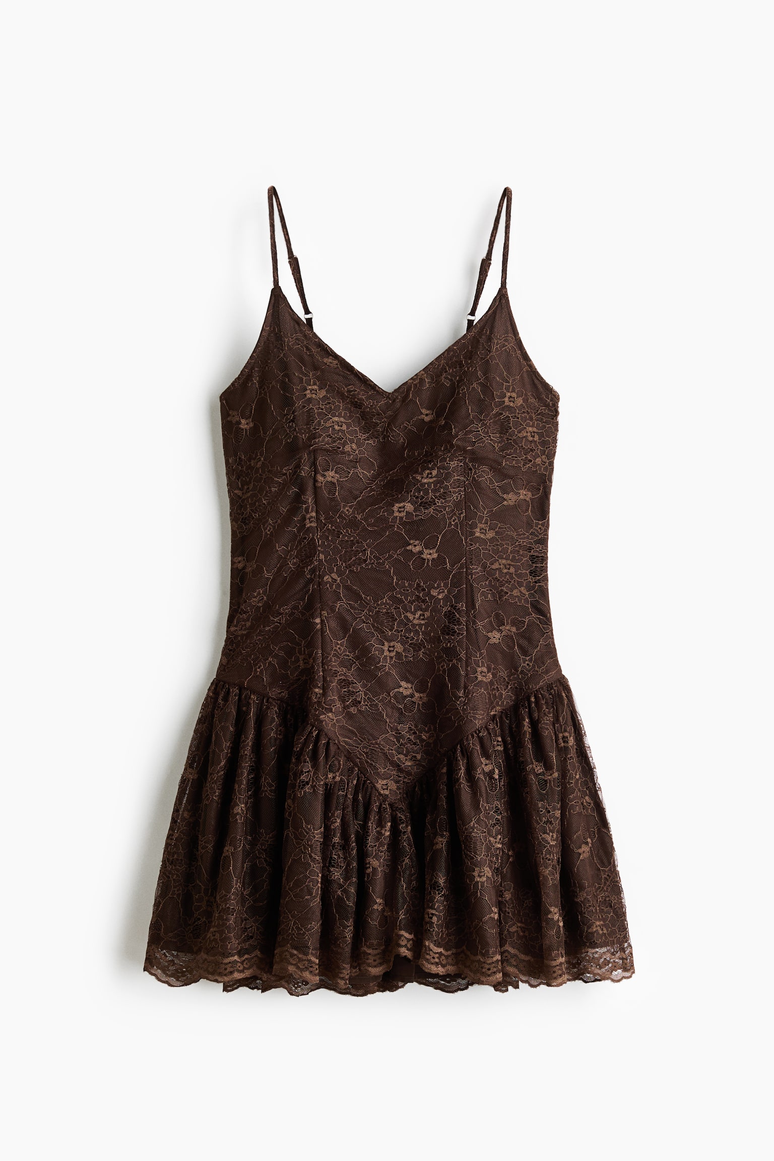 A brown lace mini dress is shown from the front, featuring adjustable spaghetti straps, a V-neckline, and a fitted bodice. The bodice extends into a dropped V-shaped waistline, which connects to a gathered, ruffled skirt with a scalloped hem.
