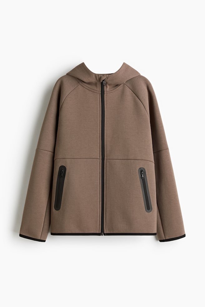 A brown sports hoodie is presenting its front, featuring a full-length black zipper down the center. It is designed with raglan sleeves, two angled black zippered pockets on the lower front, and black trim along the hem and cuffs. - 1