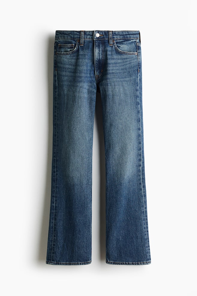 A pair of blue cotton denim bootcut jeans is shown from the front, featuring a medium wash with subtle fading on the thighs and knees. The jeans feature classic five-pocket construction, a regular waist, belt loops, a top button fastening, and legs that flare slightly from the knee to the hem. - 1