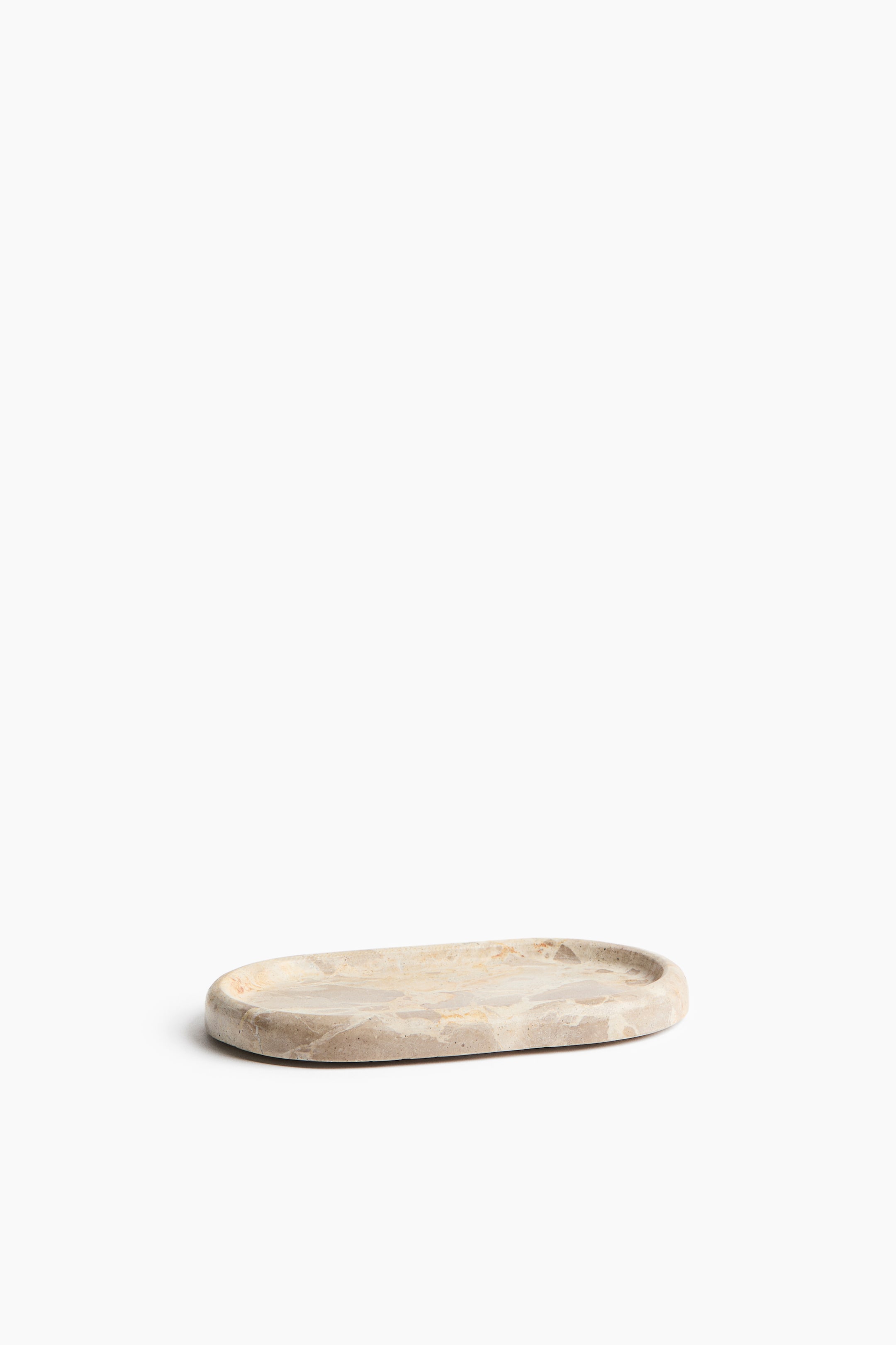 View larger image: This tray showcases an oval design with a light beige and gray marble surface, highlighted by irregular veining. It features subtly raised edges along its perimeter.