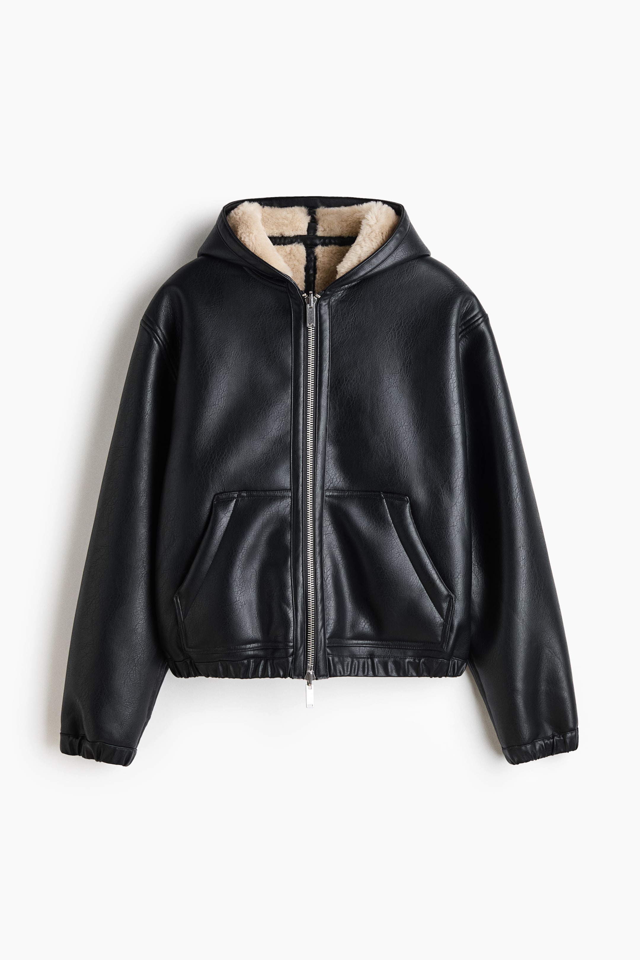 View larger image: A black faux leather hooded jacket is shown from the front, featuring a silver-tone zipper closure and a plush beige shearling lining visible inside the hood. The jacket features two front slip pockets, an elasticized hem, and elasticized cuffs.