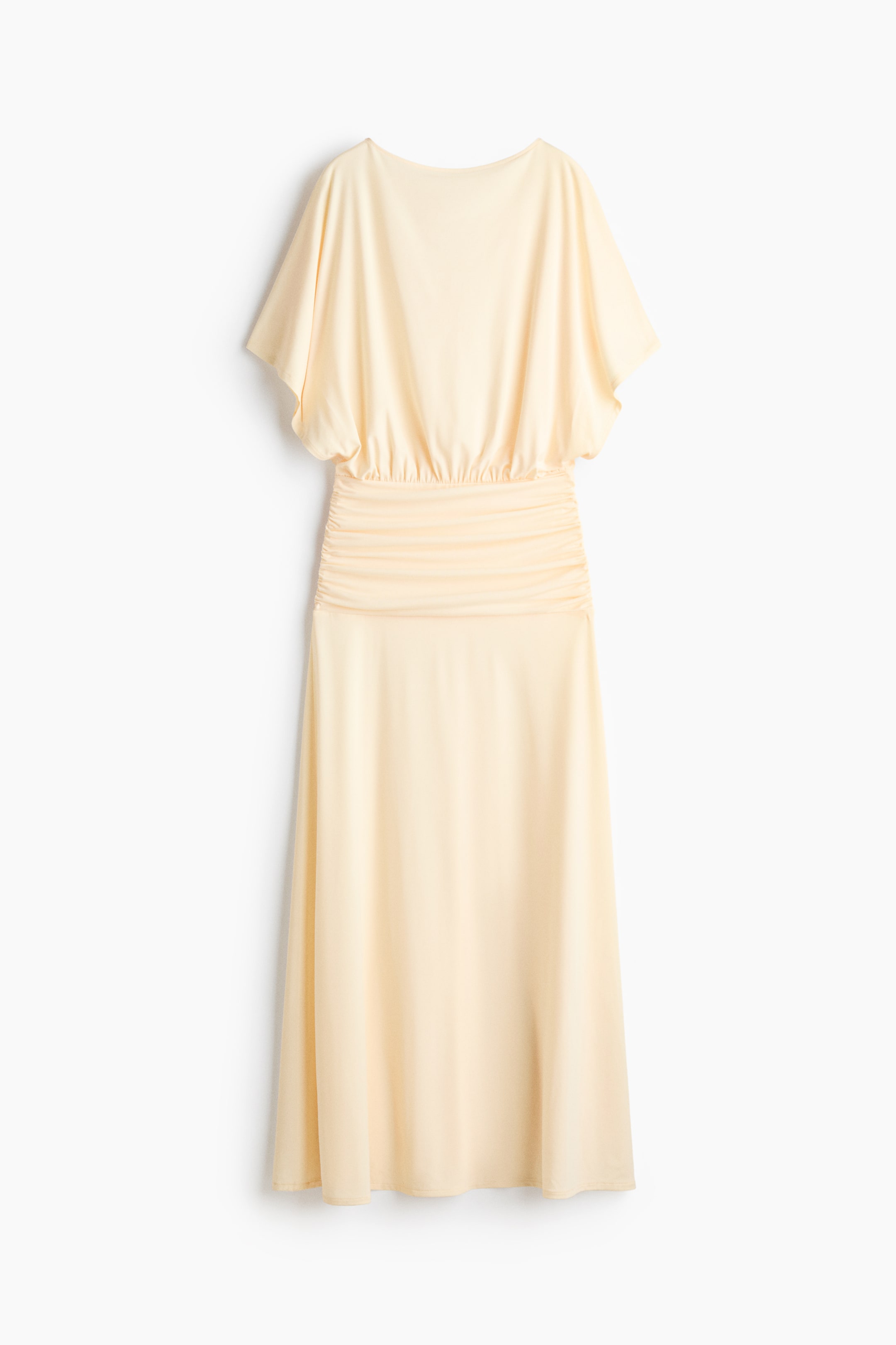 View larger image: A long dress, displayed from the front, features a soft jersey fabric, a boat neckline, and short sleeves. It boasts a loose-fit bodice, a gathered seam at the waist, a fitted and draped section across the hips, and a gently flared skirt.