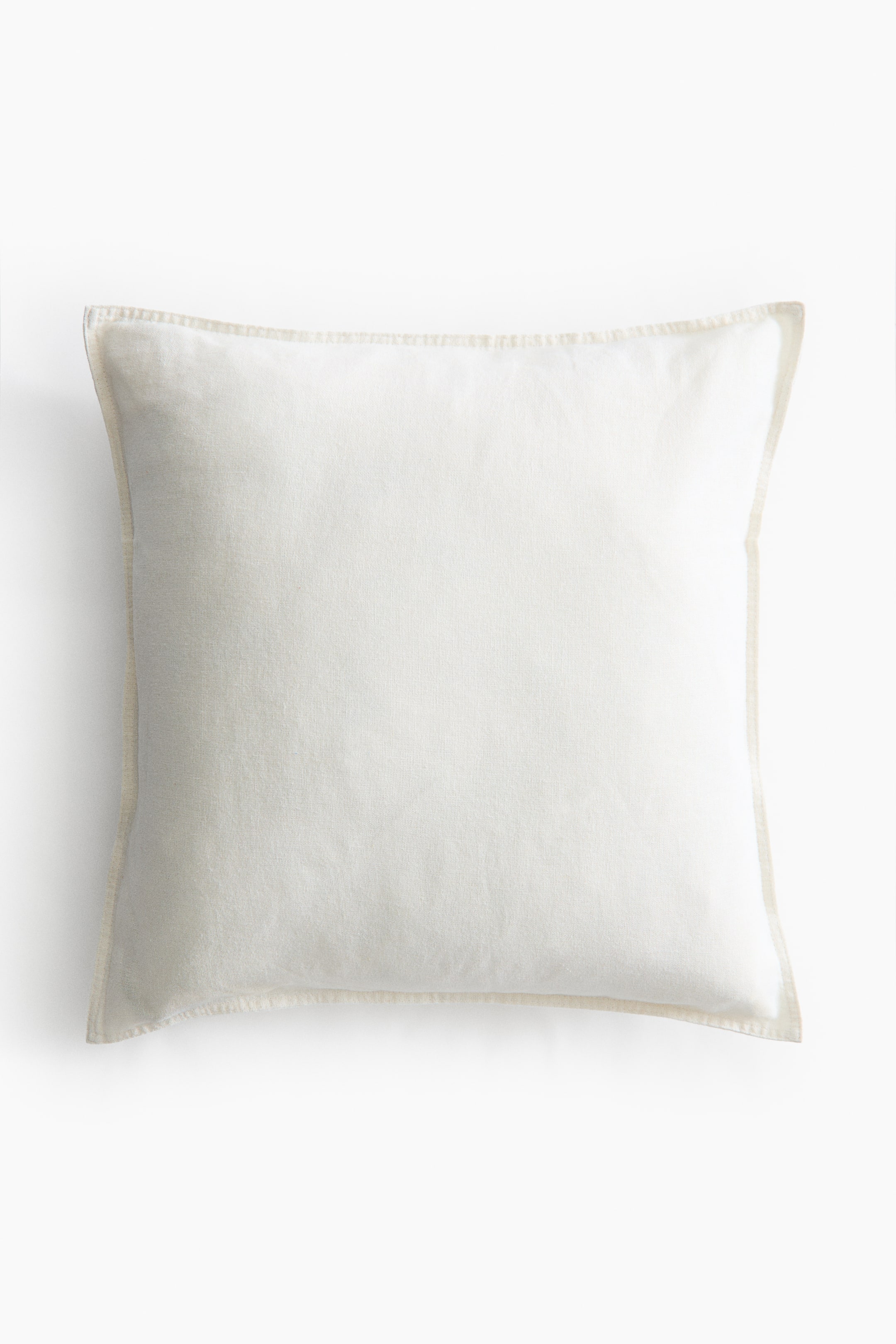 View larger image: A square cushion cover, facing FRONT, is showcasing a light off-white linen and cotton weave with visible stitching along its sides, creating a defined edge.