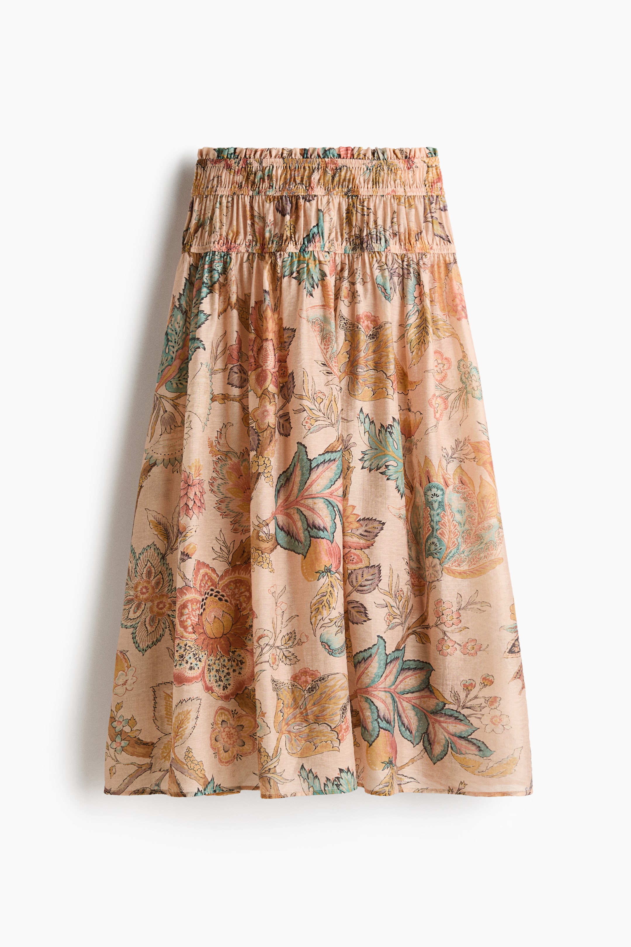 Voir une image plus grande: Une jupe de couleur pêche clair avec une taille froncée, ornée d'un motif floral et cachemire coloré dans des tons de sarcelle, rouille, jaune et vert doux, présentant une silhouette fluide en ligne A vue de face.