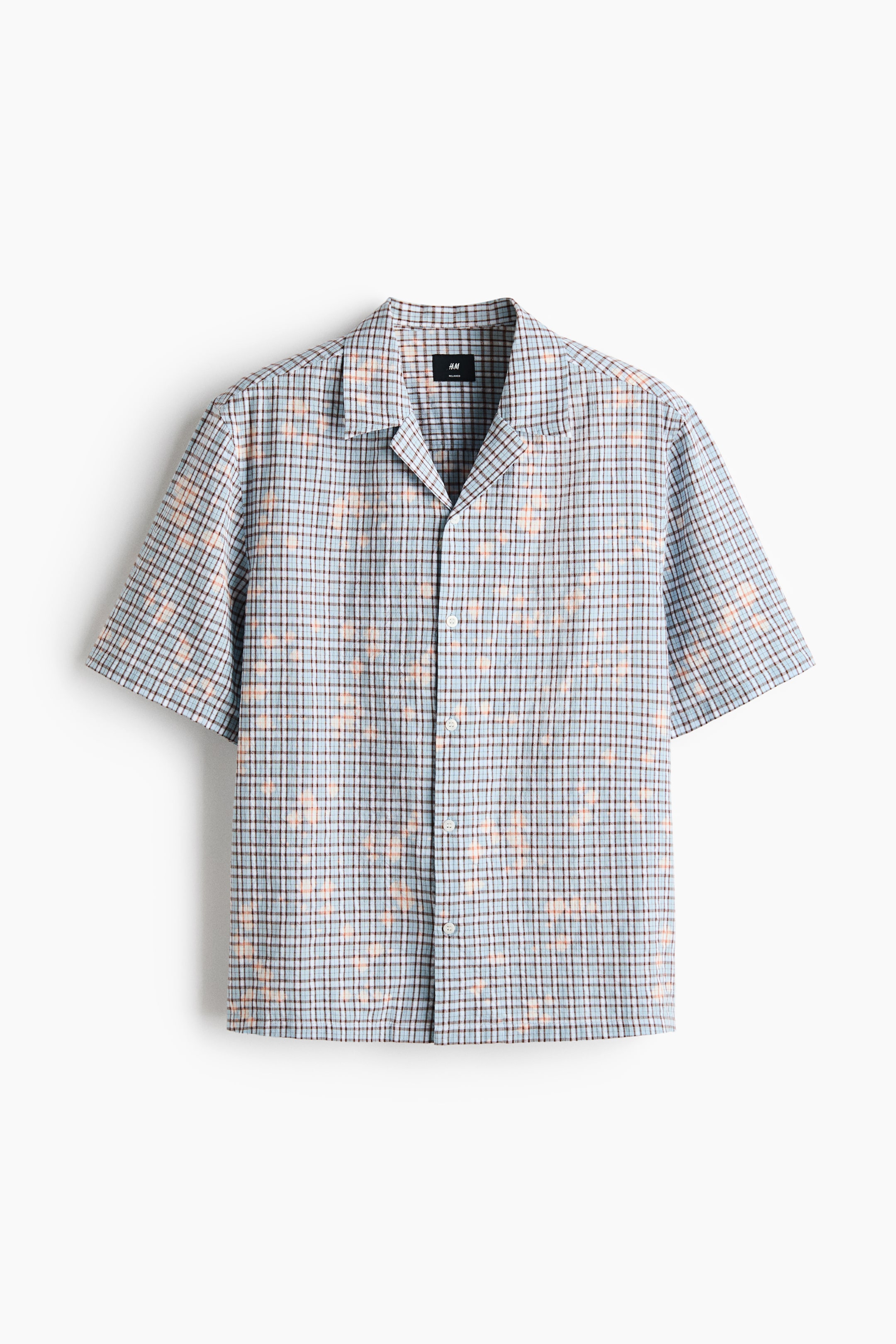 View larger image: The shirt is short-sleeved, showcasing a light blue, brown, and light orange checkered pattern from a frontal perspective. It boasts a revere collar and a button-front closure adorned with white buttons.