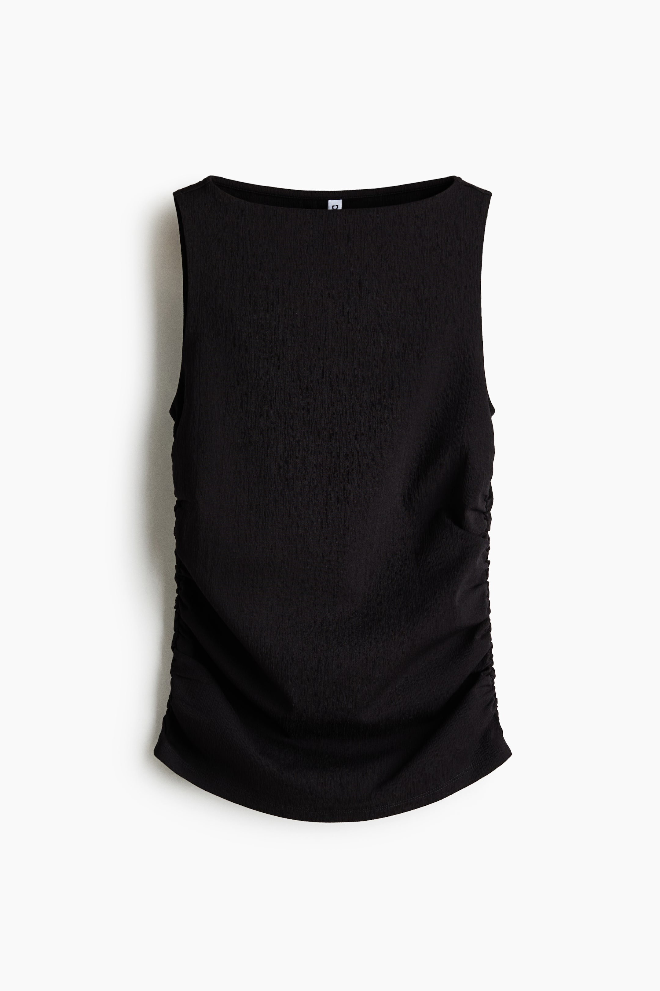 View larger image: Front view of a black sleeveless top, featuring a boat neckline and subtly textured fabric. Ruching gathers the fabric along both side seams, extending to a gently curved hem.