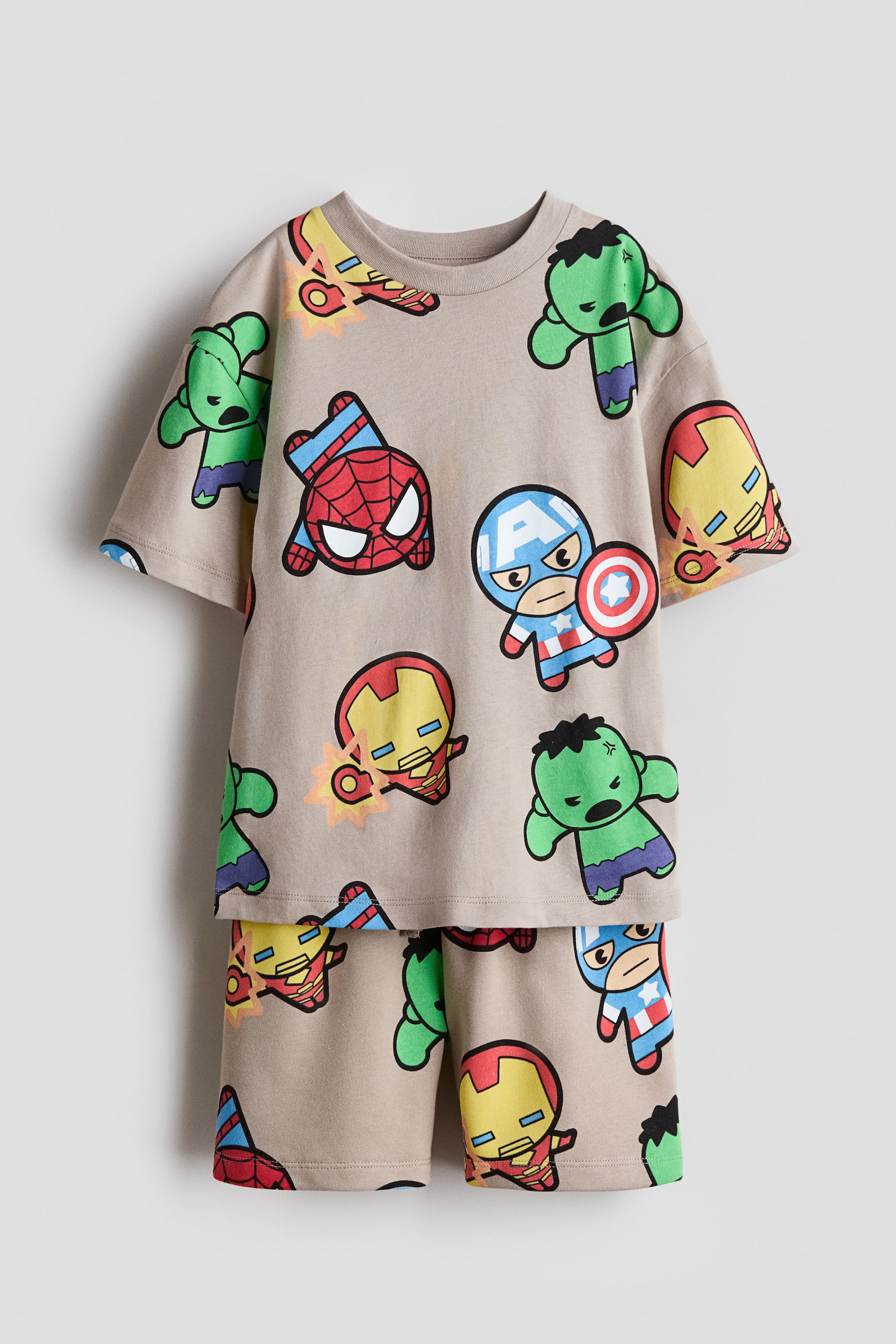 View larger image: A beige printed set, presented from the front, is featuring a T-shirt and shorts, both adorned with an all-over design of colorful cartoon-style figures. The T-shirt is showcasing a round, rib-trimmed neckline and dropped shoulders, while the shorts are featuring an elasticated, drawstring waist.