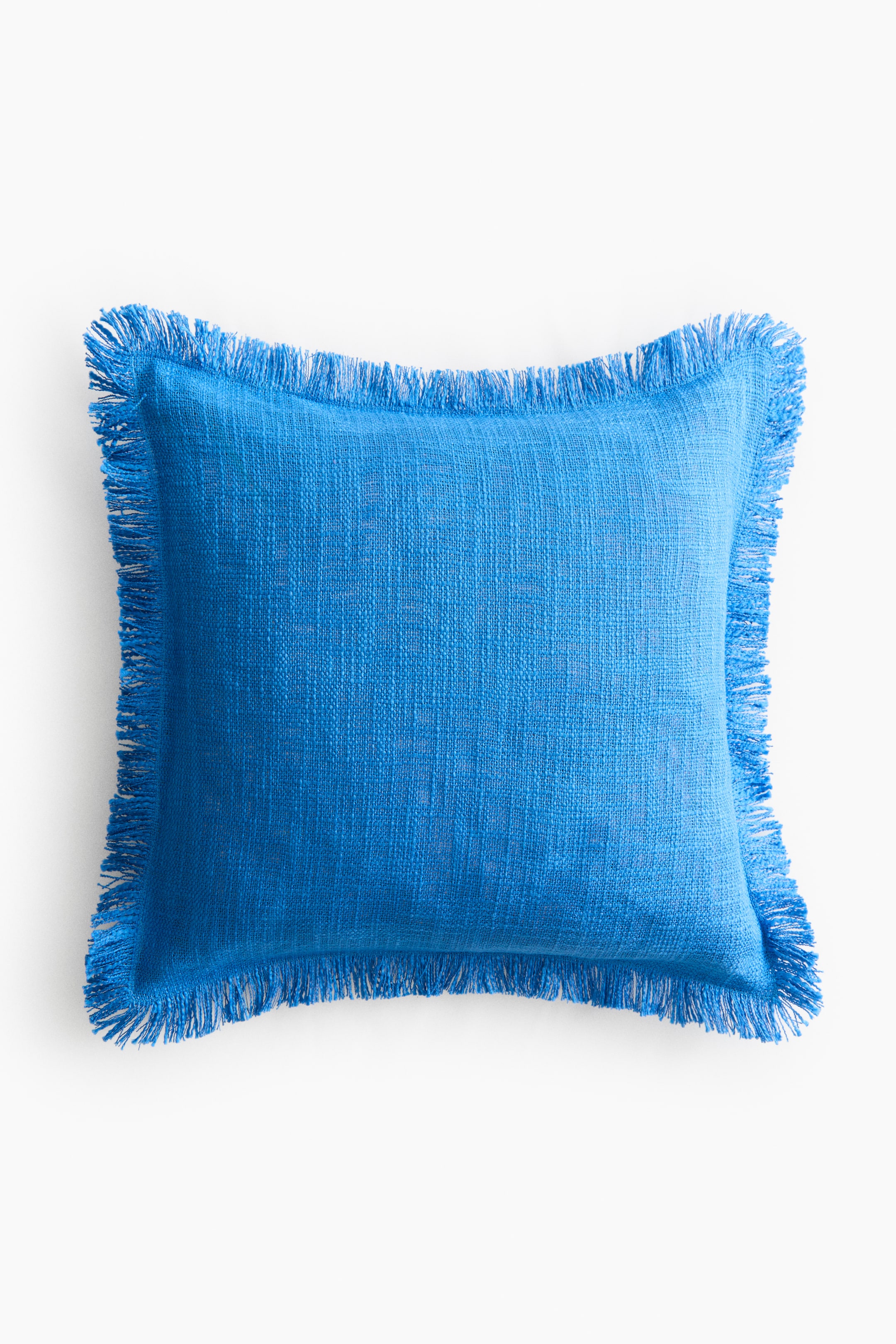 View larger image: A blue cushion cover is shown from the front, featuring a slub weave texture and fringes along all borders.