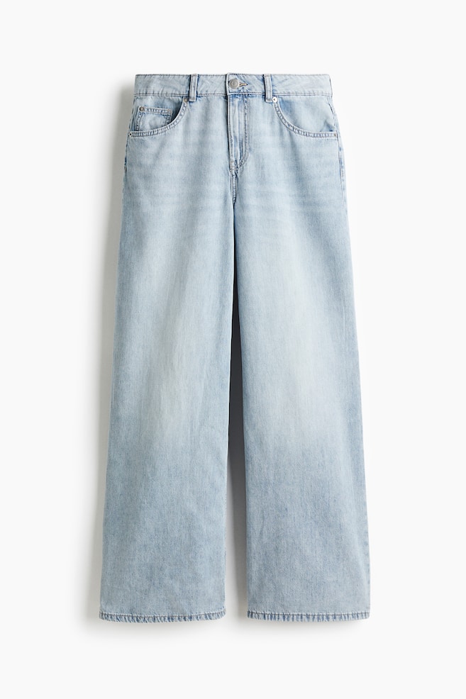 FRONT view of light blue 5-pocket jeans. They are featuring a regular waist with a button and zip fly closure, a regular fit from the waist to the hip, a long length, and a wide leg with a wide cut from the thigh to the hem. - 1
