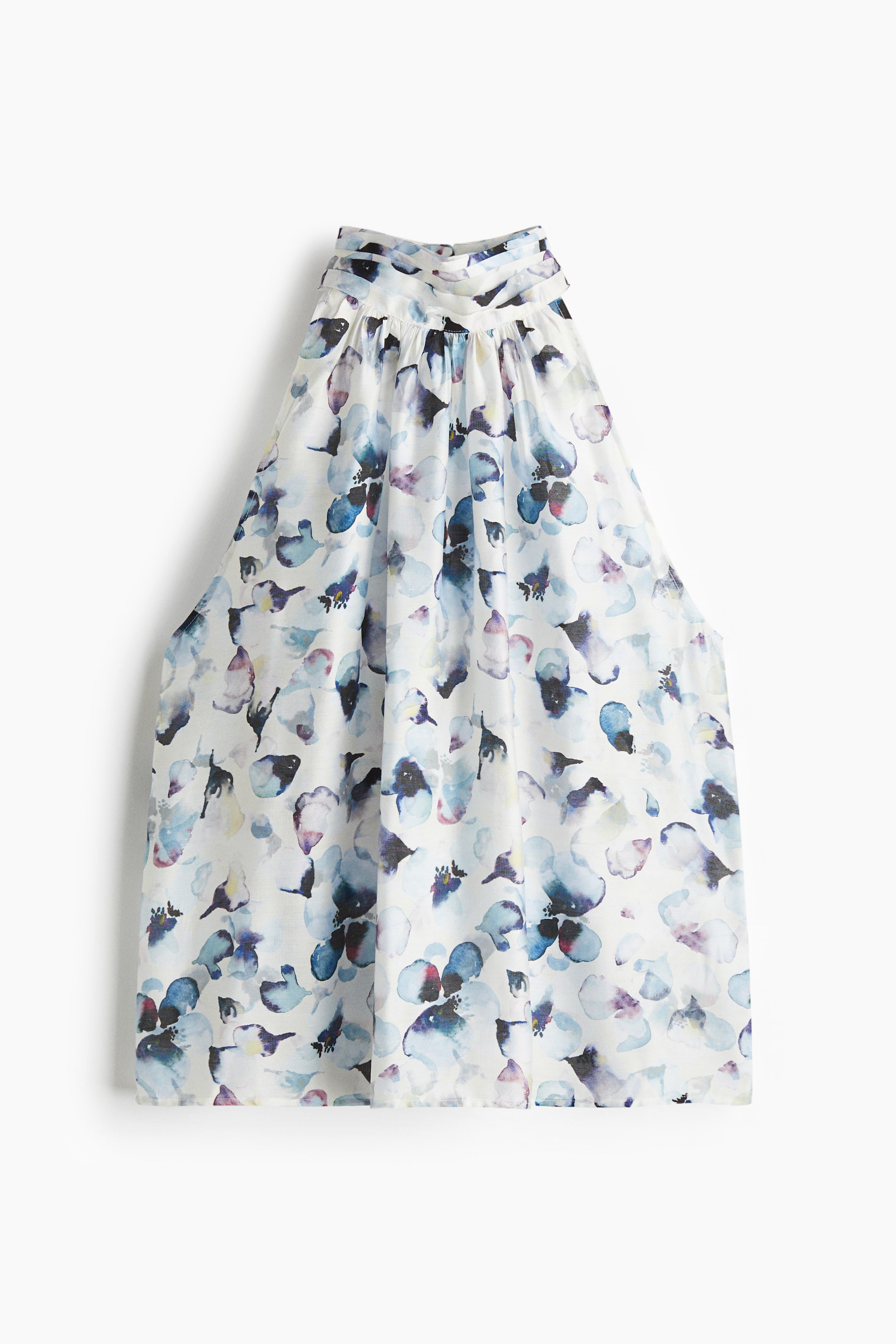 View larger image: A front-facing skirt, primarily white, is featuring an abstract watercolor floral pattern in blues and purples. It is designed with a wide, gathered waistband and side seam pockets.