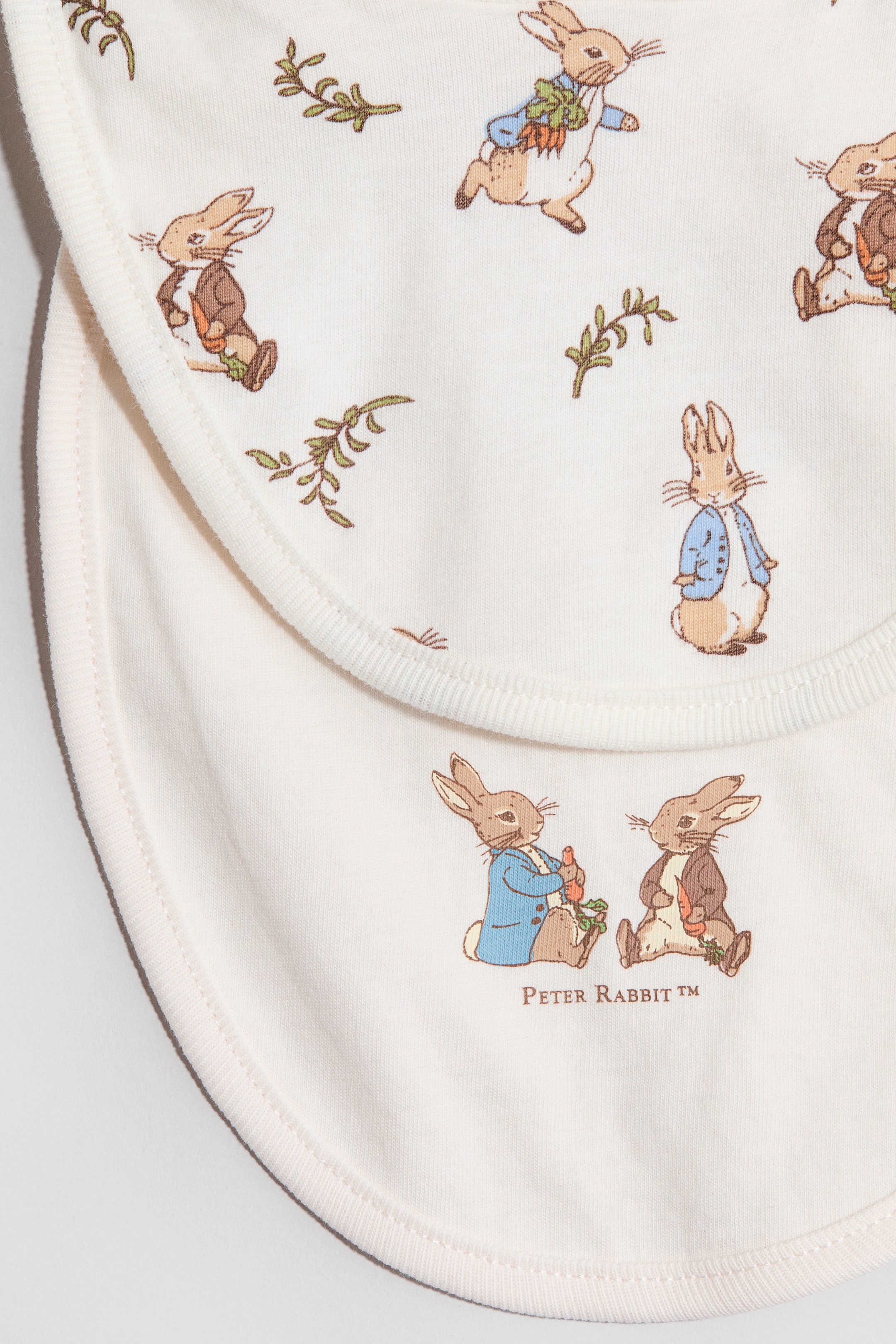 View larger image: 2-pack printed cotton jersey bibs - Cream/Peter Rabbit - Kids | H&M 2