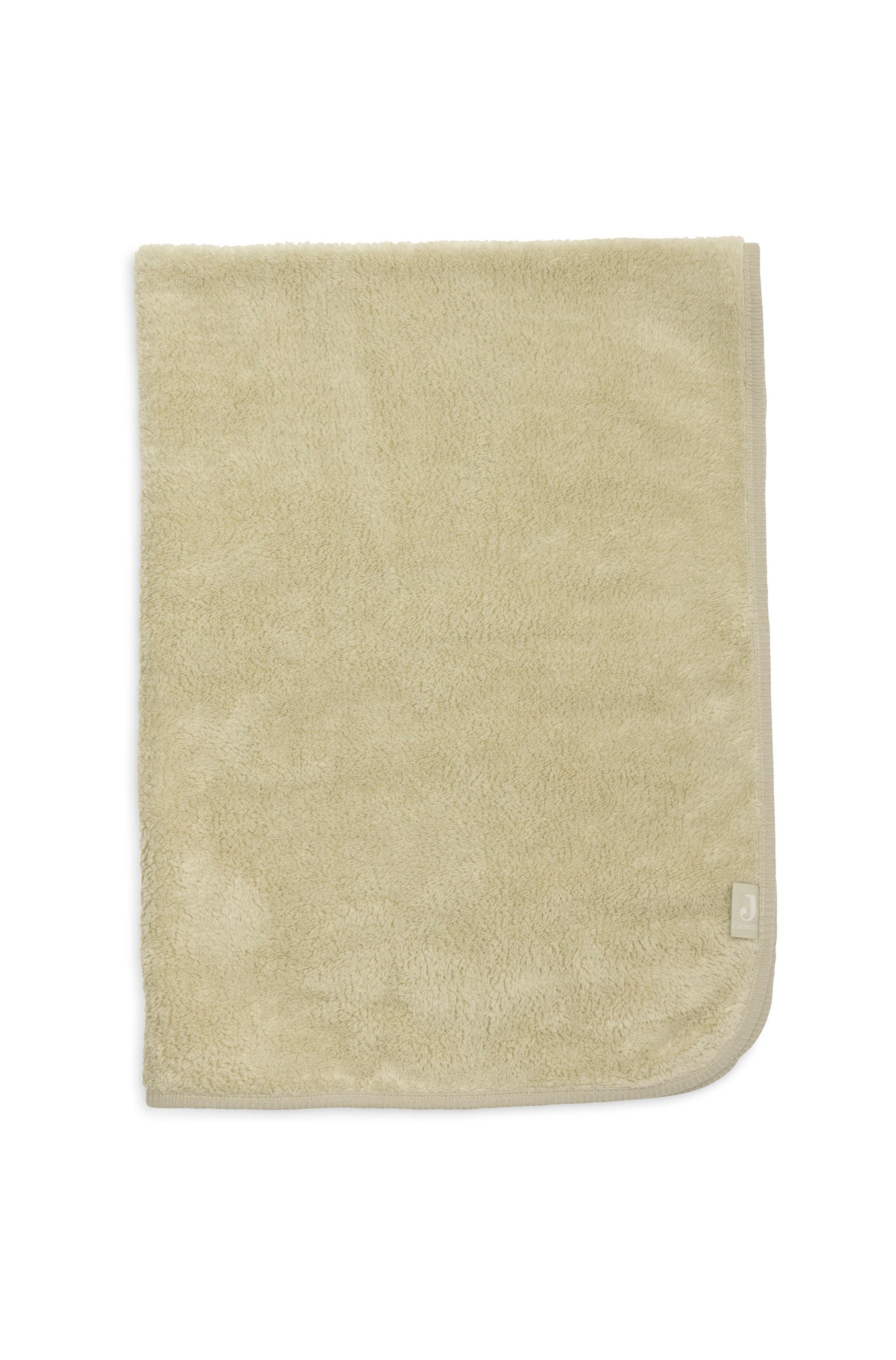 Agrandir l'image: Une couverture polaire moelleuse rectangulaire dans une teinte vert sauge atténuée est posée à plat, mettant en valeur sa texture douce et duveteuse. Elle est dotée d’une finition en tissu côtelé assorti le long des bords inférieur et droit, avec une petite étiquette en tissu cousue près du coin inférieur droit arrondi.