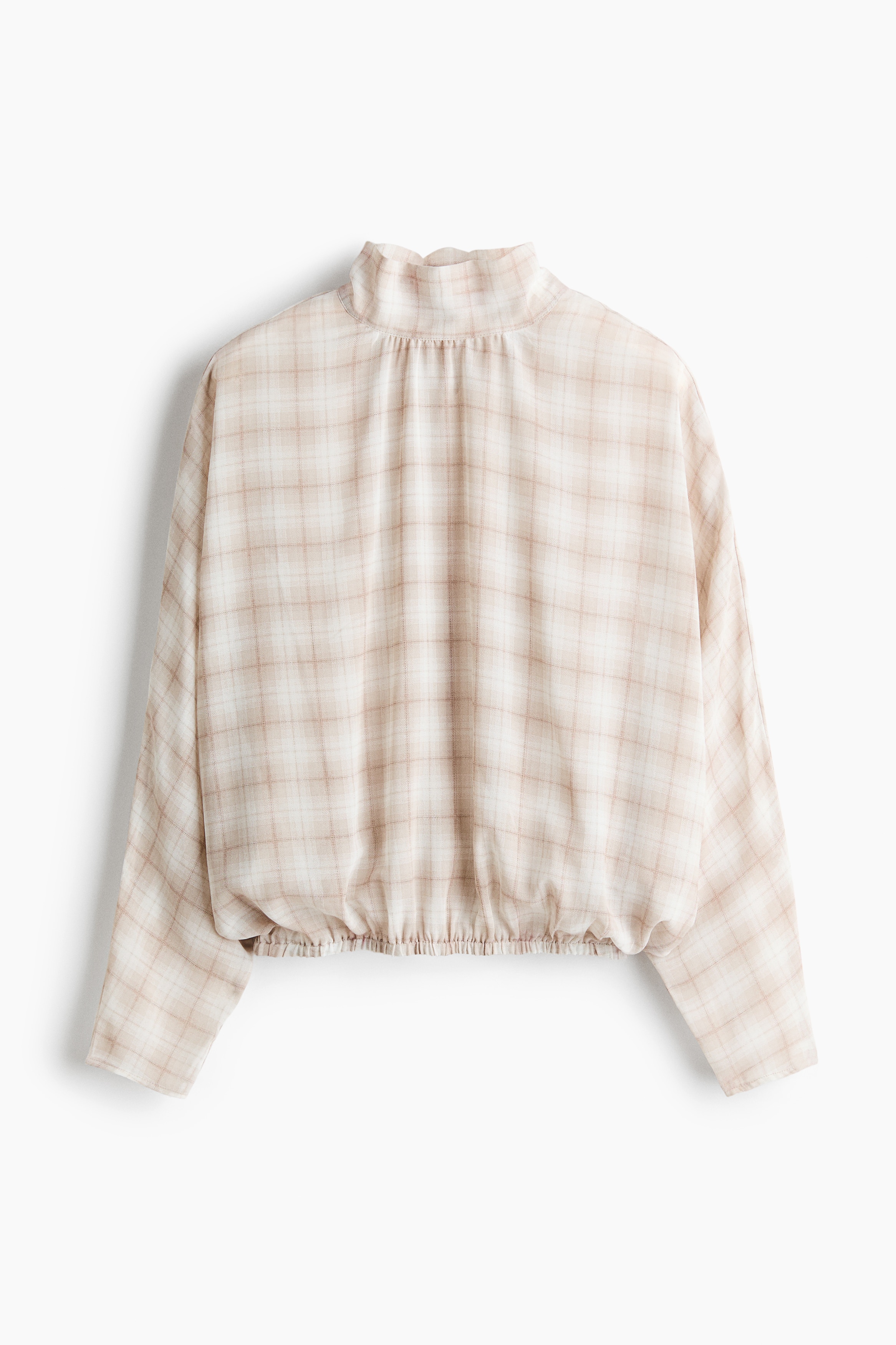 A tie-back stand-collar blouse in a beige plaid pattern is draping loosely in a front-facing view. The blouse features a high, gathered stand collar and long, relaxed sleeves tucked into denim jeans.