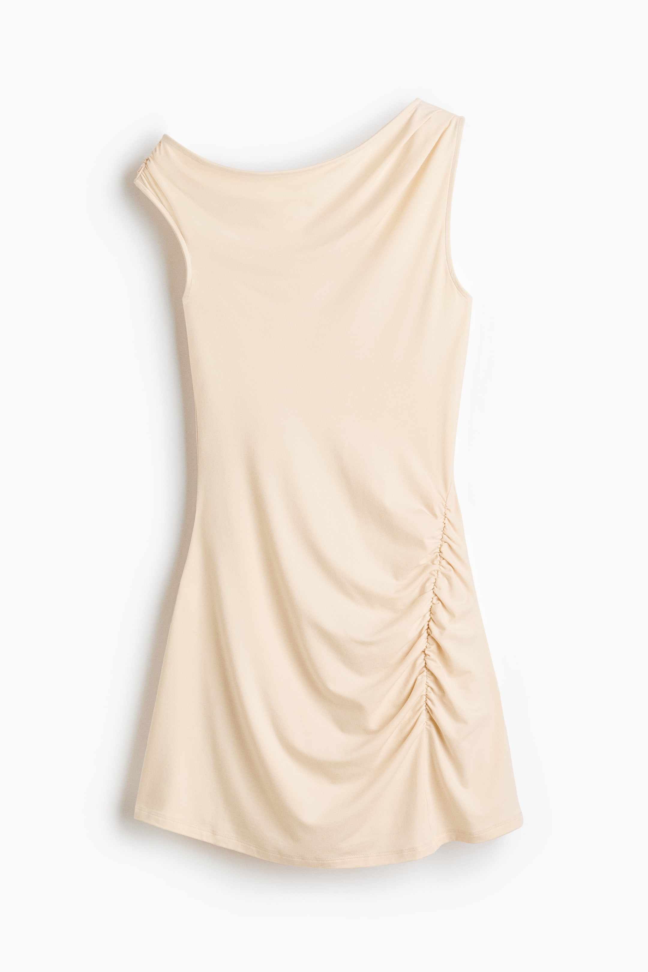 View larger image: A light beige sleeveless dress is shown from the front, featuring an asymmetrical neckline with draping and ruched detailing down the right side.
