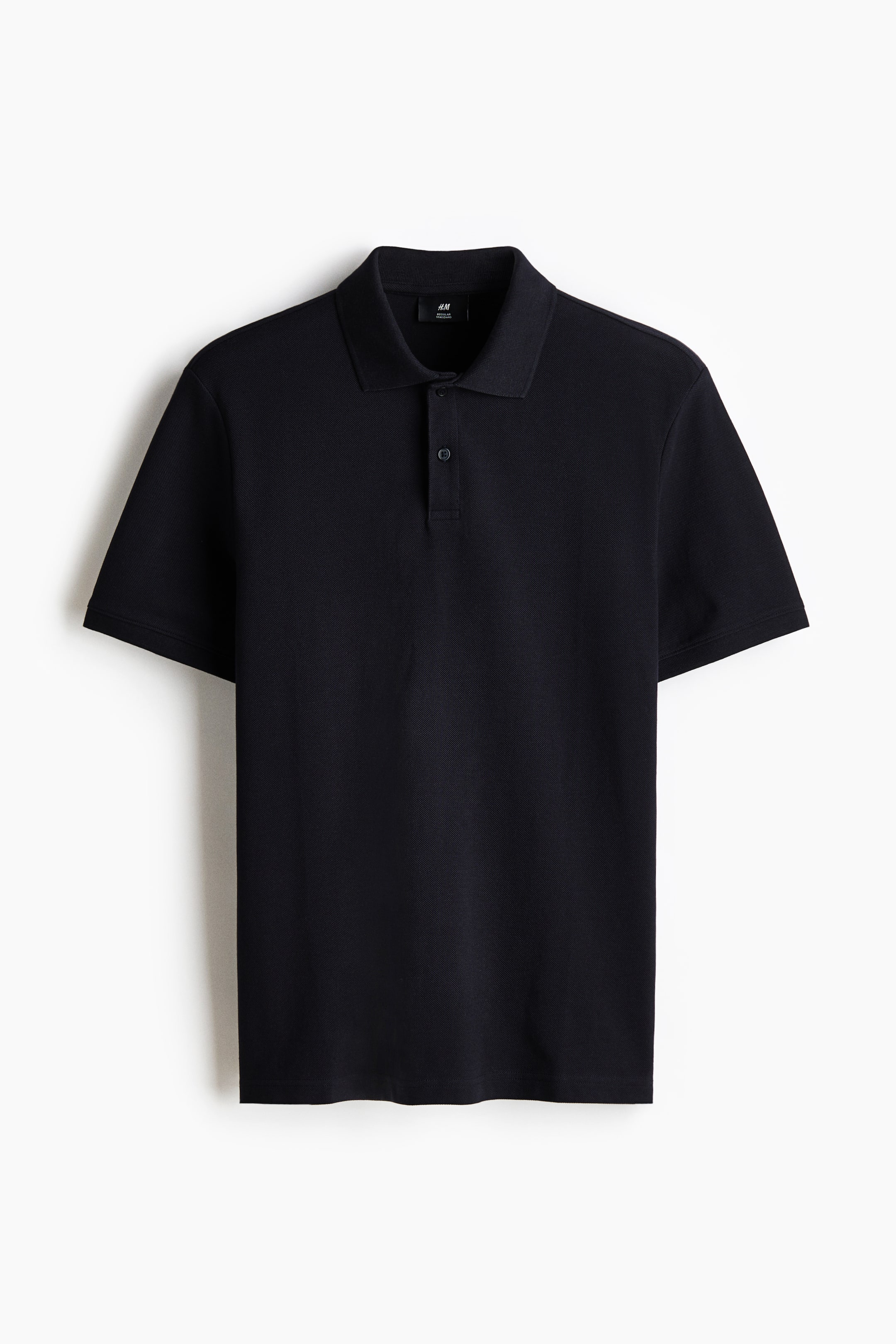 View larger image: A black pique knit polo shirt is displaying its front, featuring a classic collar, a two-button placket, and short sleeves.