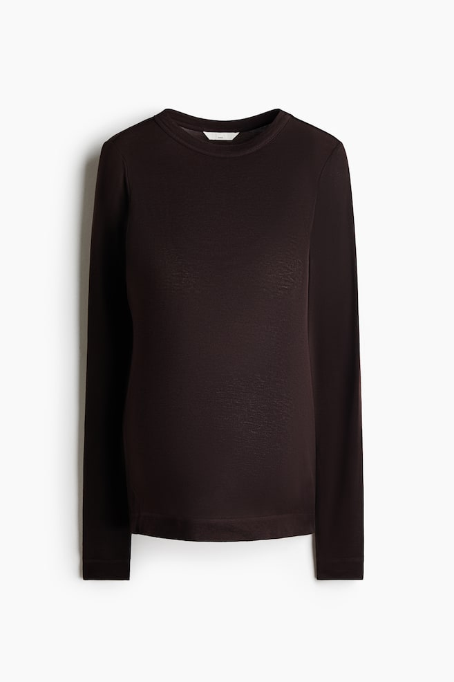 A dark brown long-sleeved top is shown from the front, featuring a ribbed crew neck collar, long sleeves and a straight hemline. The lightweight, fine-knit fabric presents a clean, classic silhouette. - 1