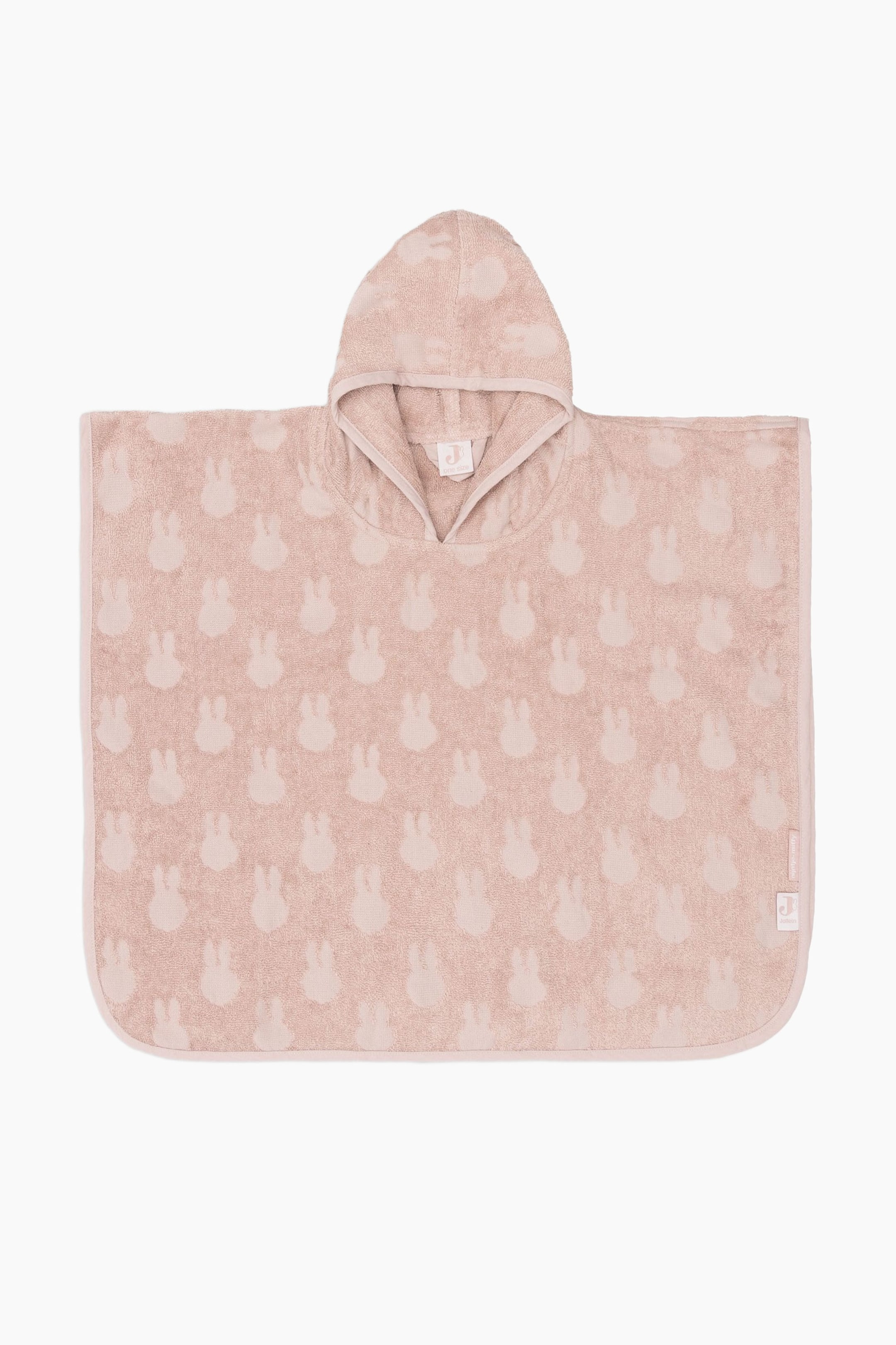 View larger image: A light pink hooded towel poncho is lying flat, featuring a repeating all-over pattern of subtle bunny heads. The poncho is designed with a V-neck opening and rounded bottom corners, and is finished with a thin border binding its edges.