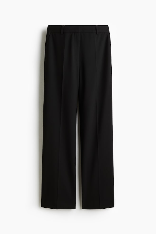 Black woven trousers are displayed from the FRONT, featuring a high waist and a concealed zip fly with button and hook-and-bar fastening. Diagonal side pockets are visible, and straight legs are showing creases down the front. - 1