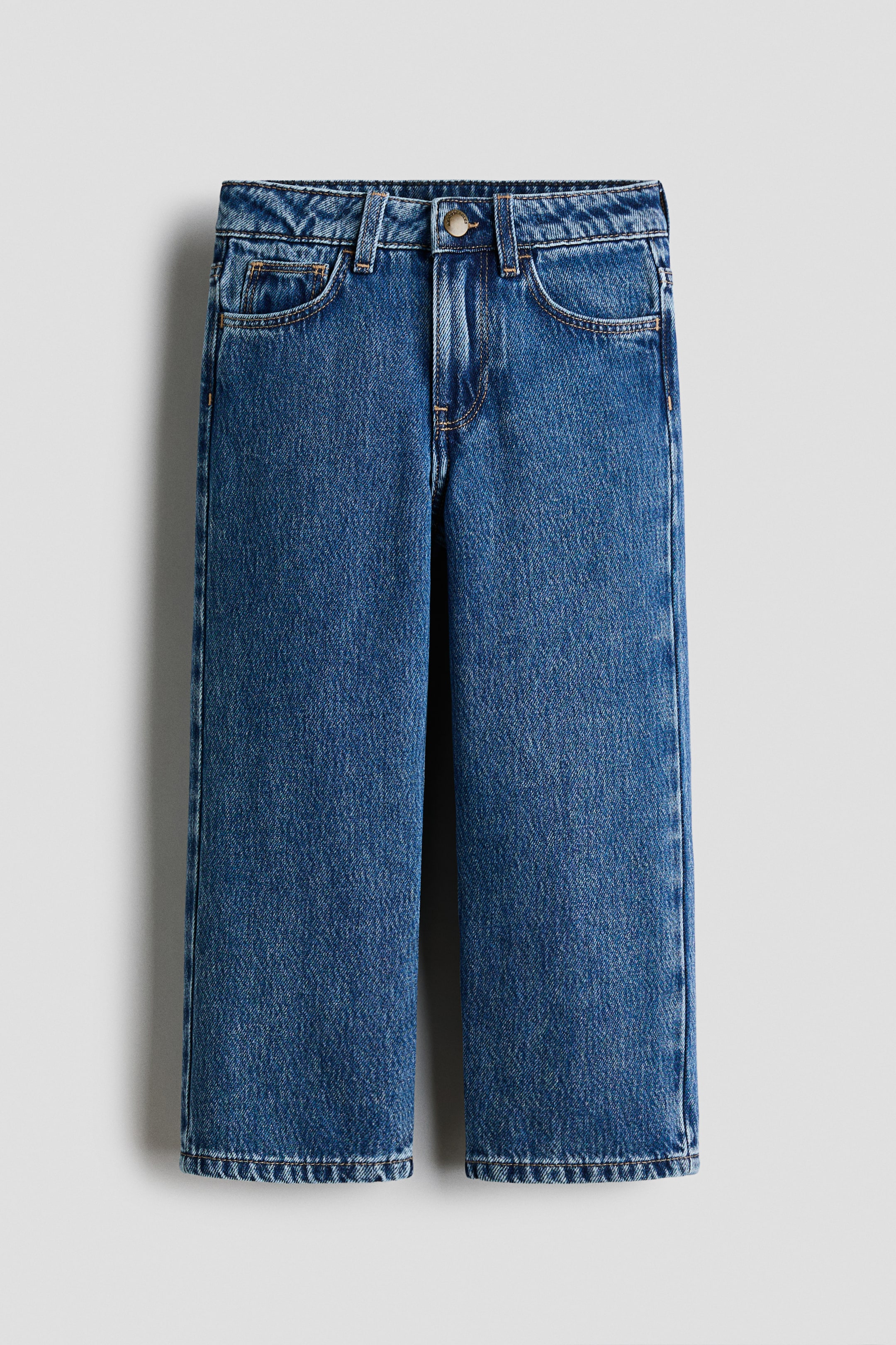 Agrandir l'image: Jeans en denim bleu avec une coupe droite et un délavage moyen, dotés d'une fermeture à boutons et zip, de poches avant en biais et de coutures contrastées.