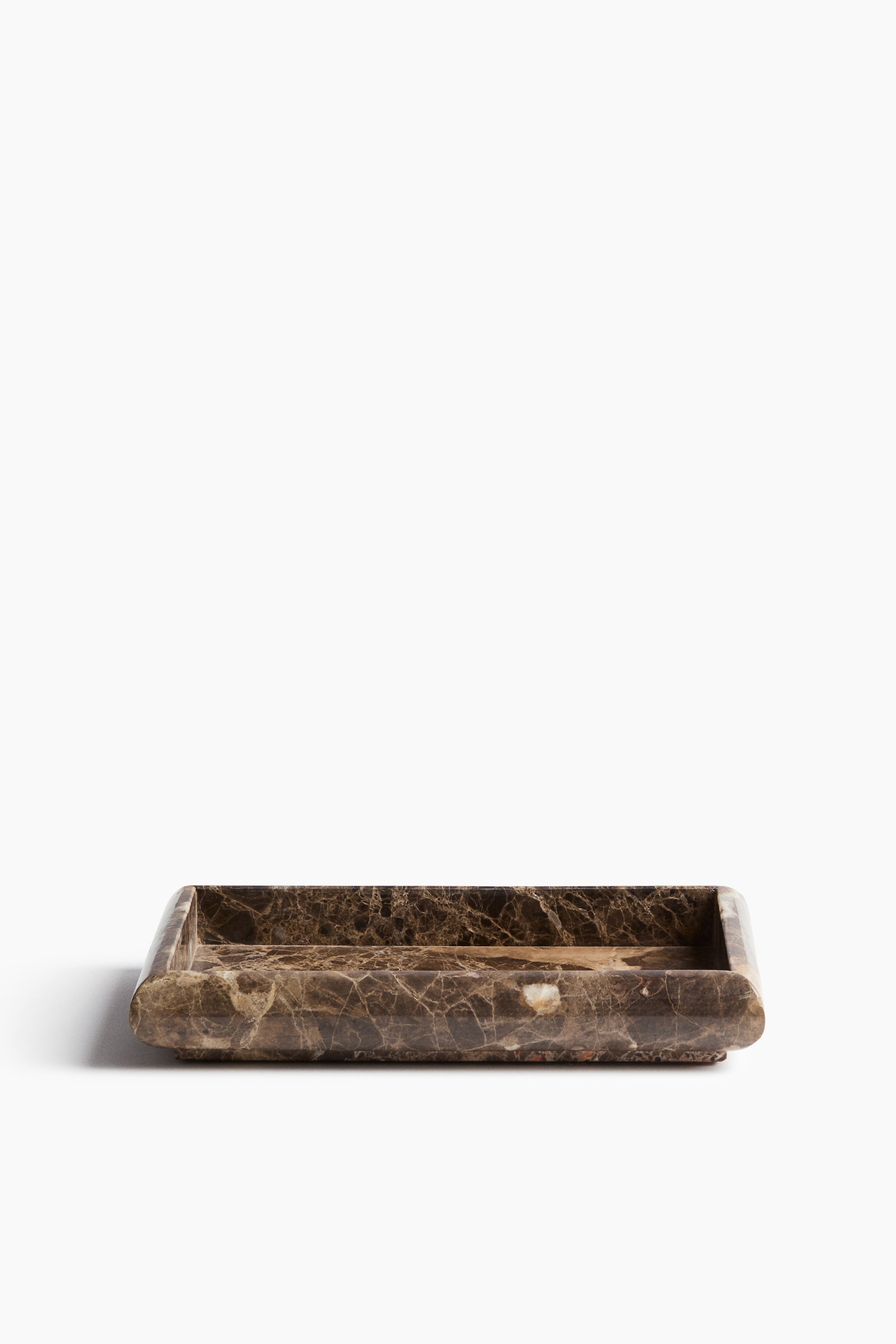 View larger image: A rectangular marble tray is being displayed, featuring a dark brown colour with intricate white and lighter brown veining. It forms a shallow, rectangular basin and presents subtly rounded exterior corners.