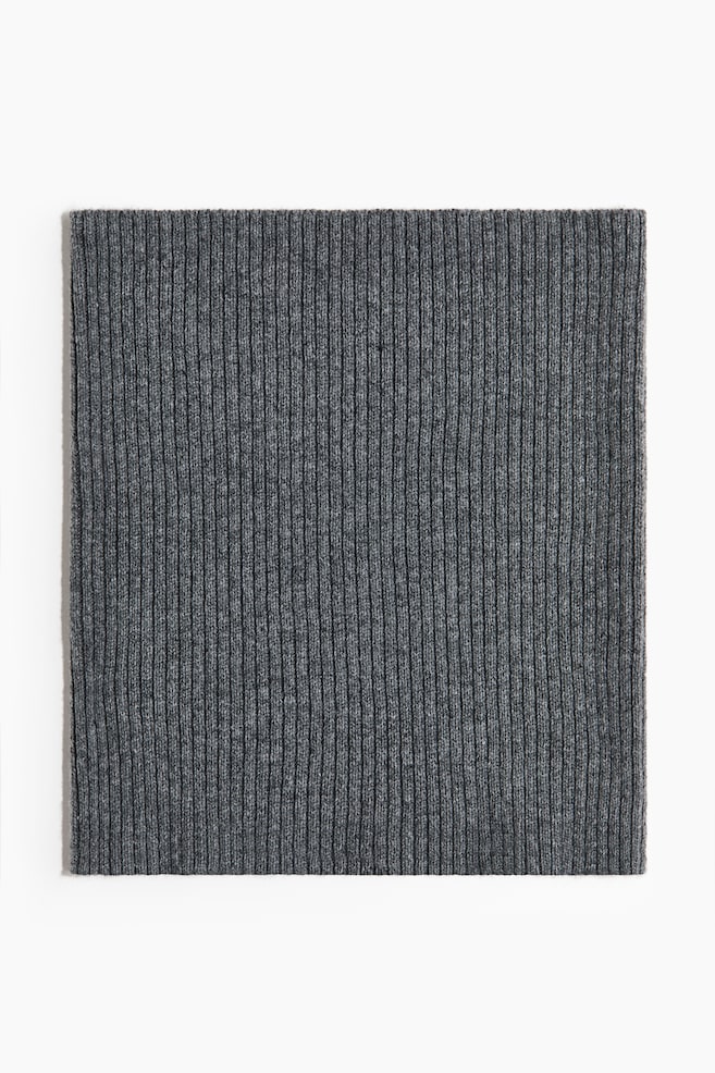 Grey ribbed fabric is lying flat, displaying a consistent vertical knit pattern. - 1