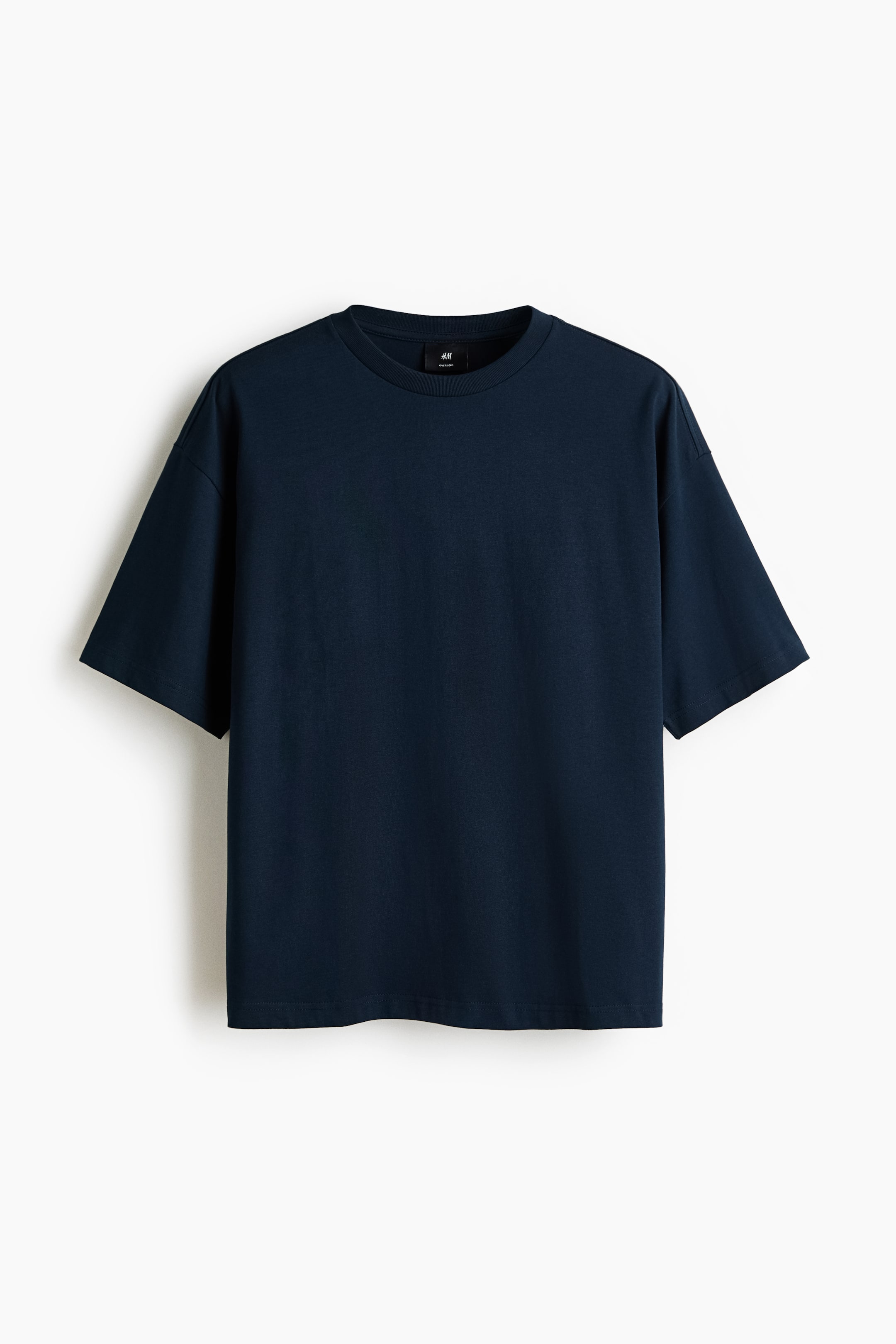 View larger image: A dark blue boxy-style T-shirt in cotton jersey is shown from the front, featuring a ribbed crew neckline and dropped shoulders. It has an oversized fit with a straight-cut hem, creating a baggy, extra-loose silhouette.