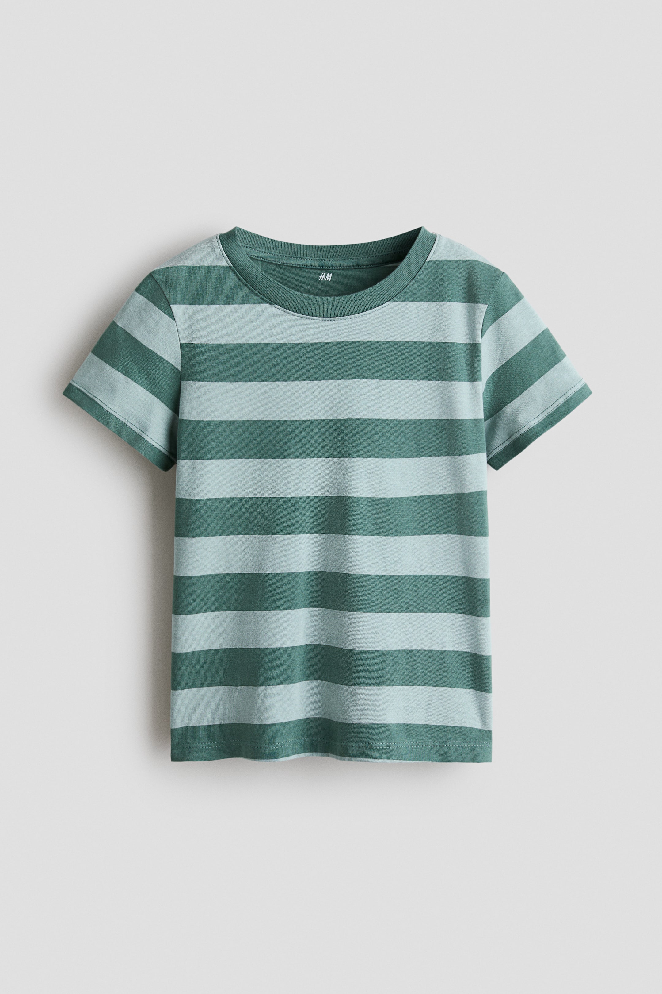 View larger image: "A T-shirt made of soft cotton jersey is displayed front-facing, showcasing horizontal stripes in dual green tones, a round neckline with ribbed detailing, and short sleeves."