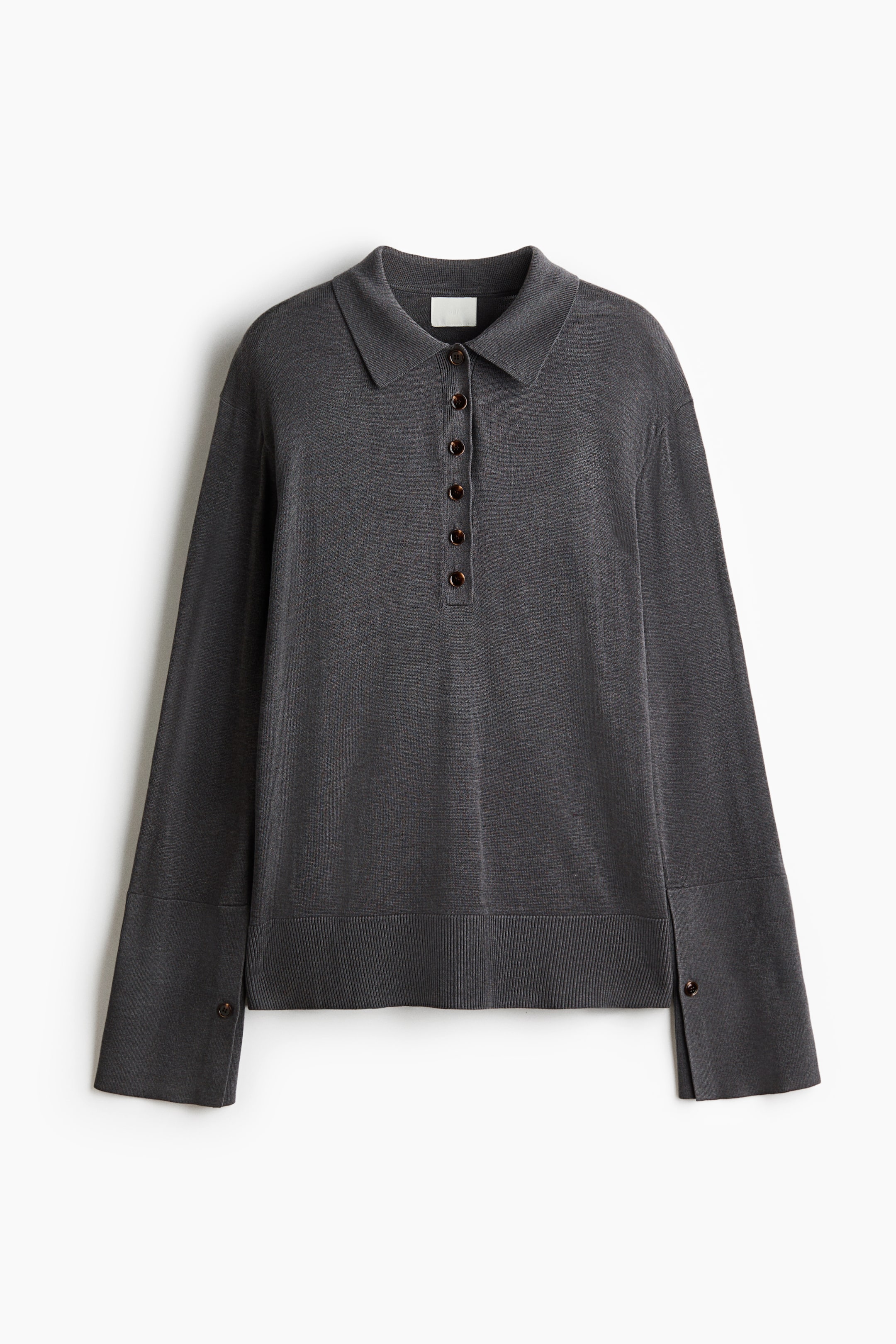View larger image: A front-facing view of a dark gray, fine-knit polo shirt shows a classic collar with a six-button placket and dropped shoulders. The long sleeves feature wide cuffs with a long slit and a single button, while a ribbed band finishes the hem.