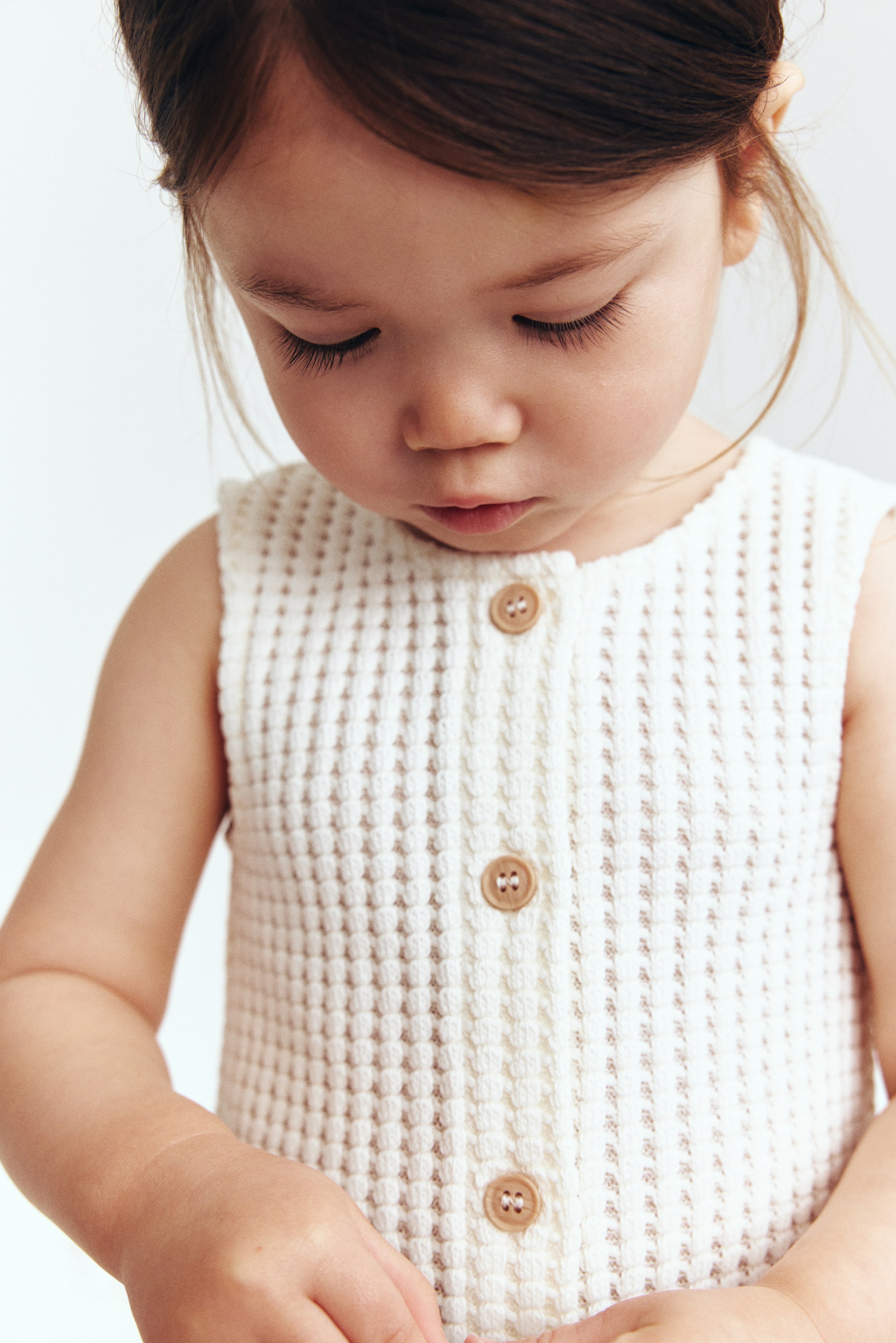 Barboteuse en tricot gaufré