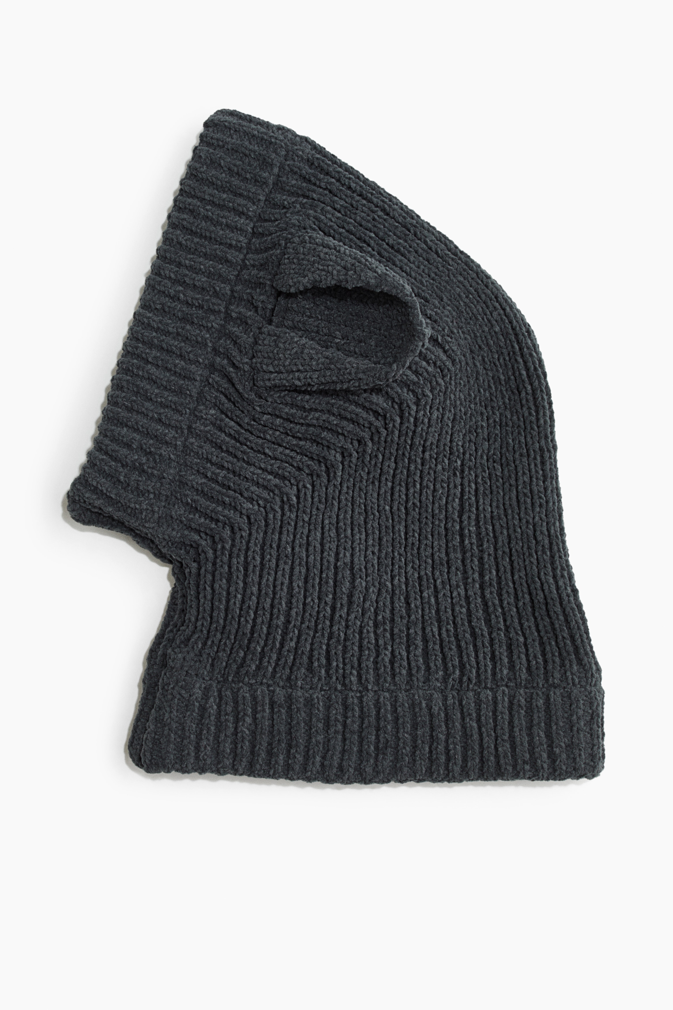 A dark grey rib-knit dog balaclava is being worn by a brown and white dog, showcasing its front fit and design. The balaclava features side openings for the ears and a thick, sewn-in turned-up collar wrapping around the neck.