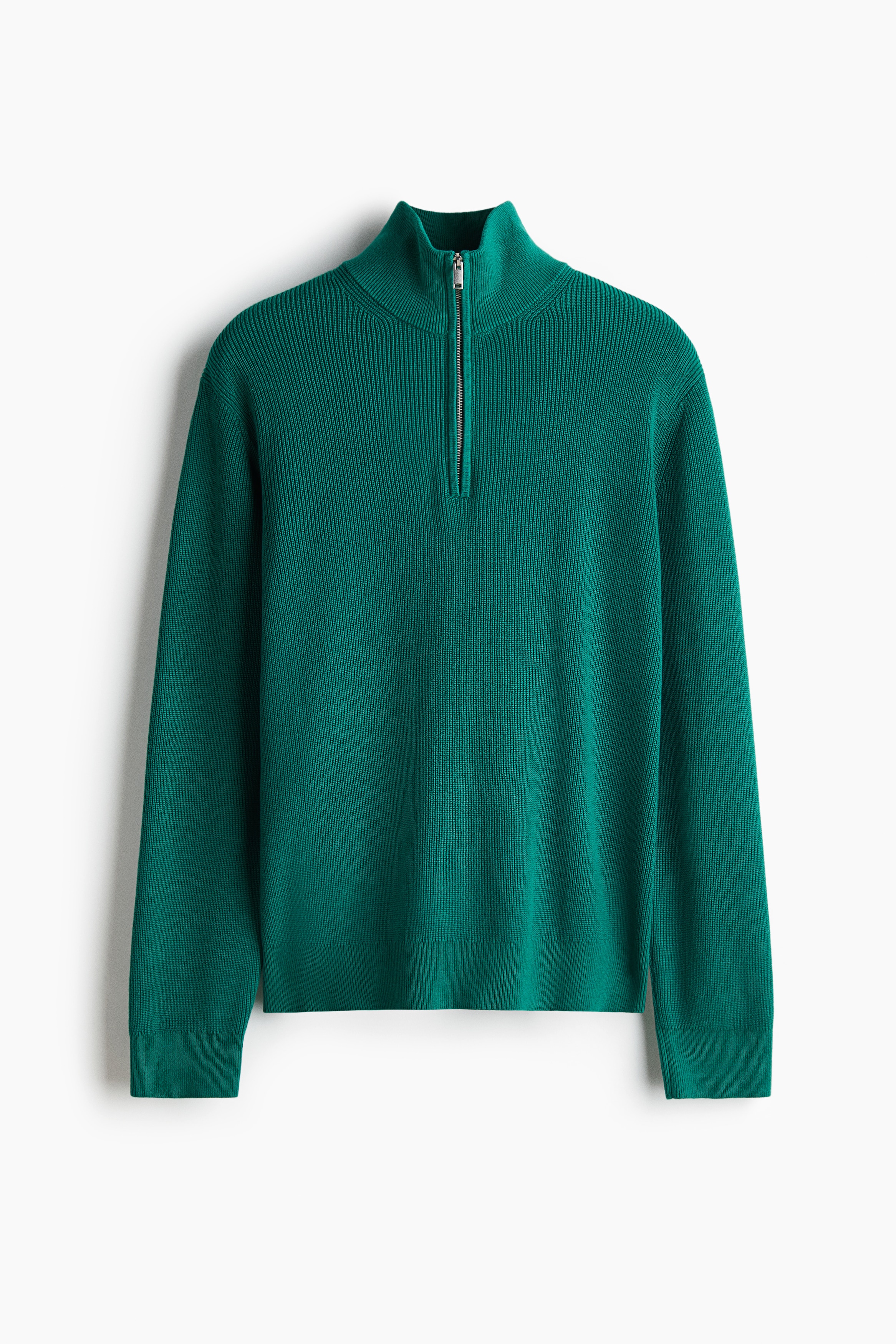 A green rib-knit sweater featuring a stand collar with a silver half-zip is being worn by the model over a striped T-shirt. The sweater has a regular fit with ribbed cuffs and hem and is paired with light-wash jeans.