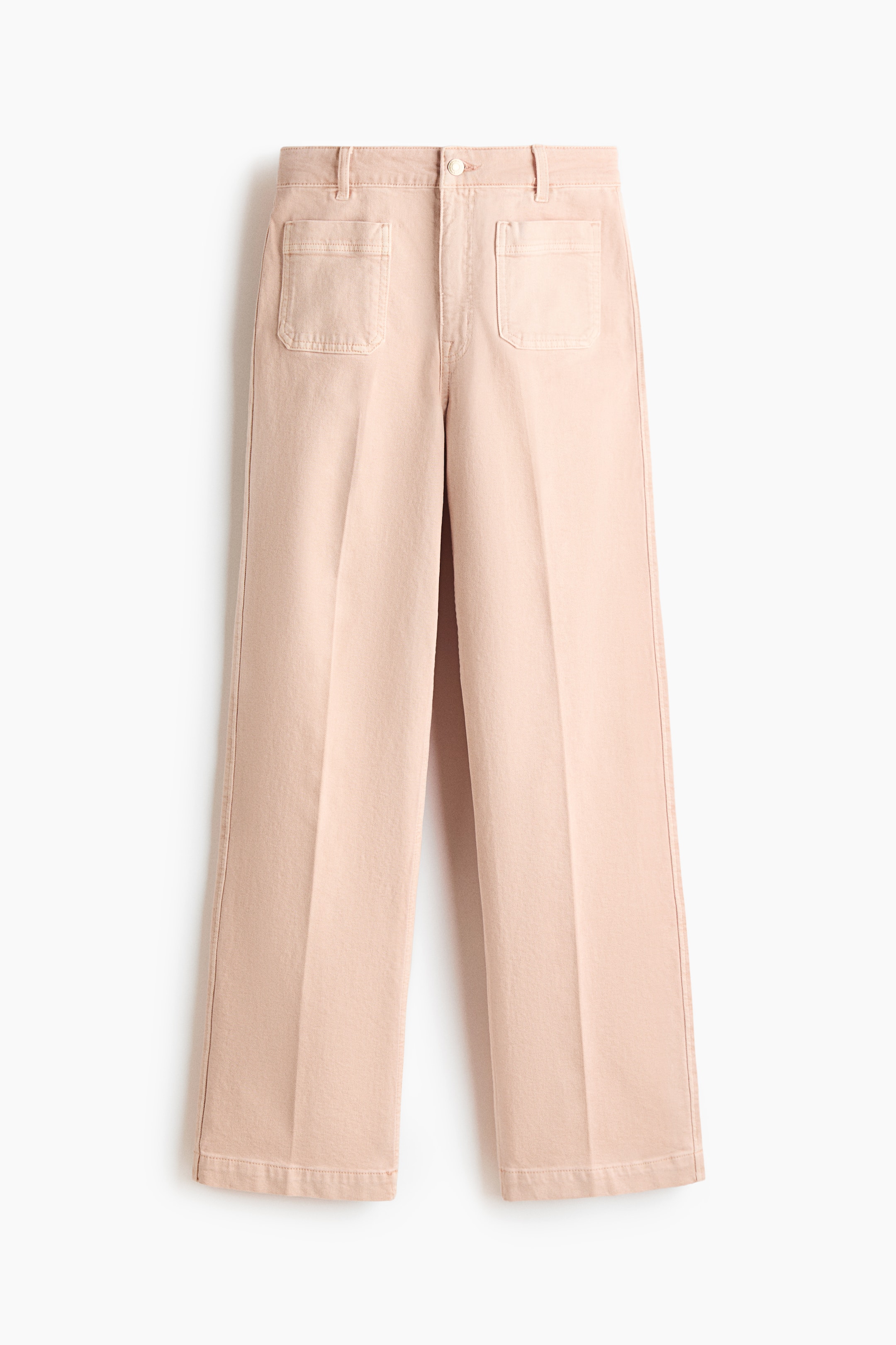 View larger image: Front-facing, pale pink cotton denim jeans are displaying a high waist with a zip fly and button closure. They are featuring a regular fit from the waist to the hip, wide legs from the thigh to the hem, front patch pockets, and creases running down the front.