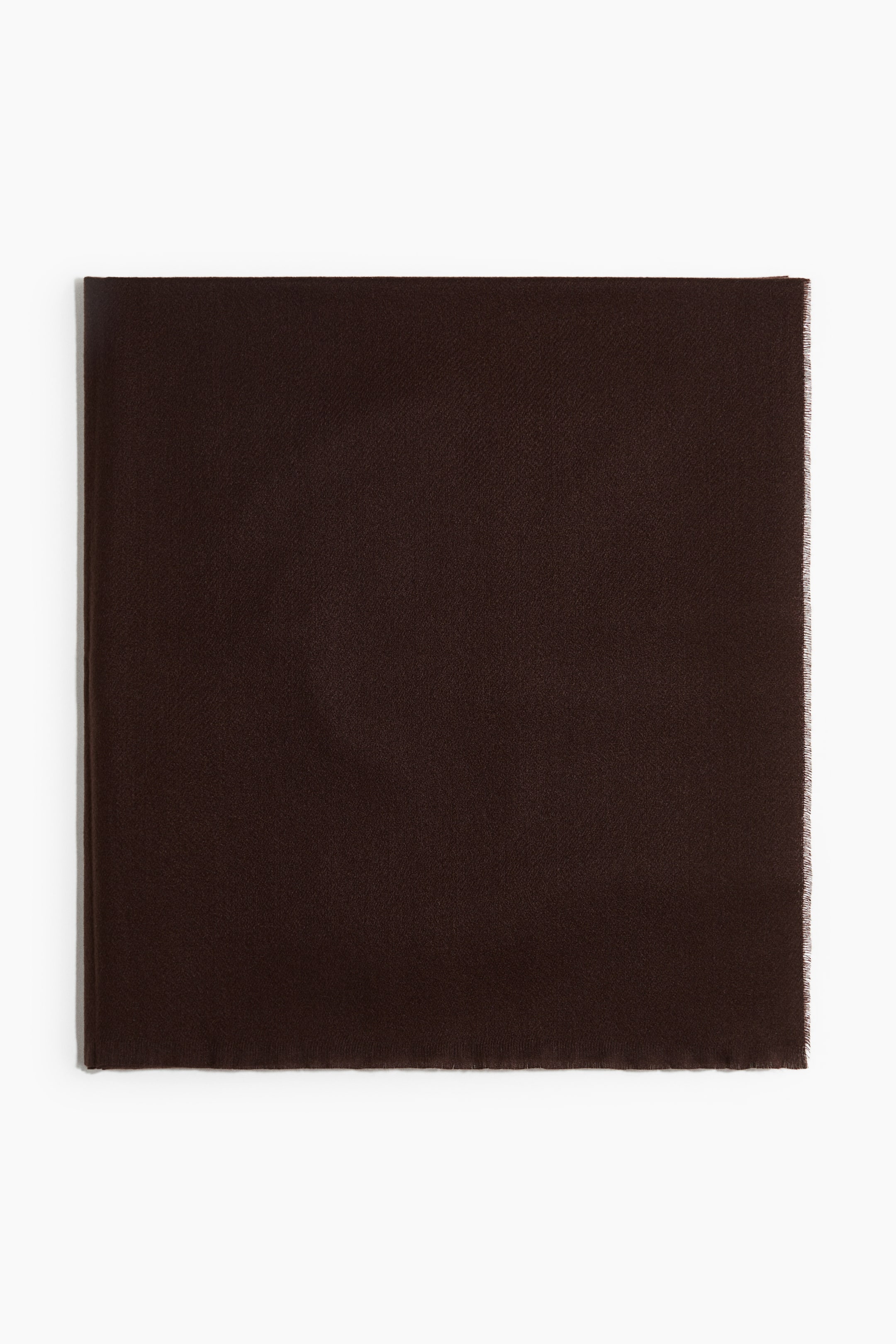 View larger image: A dark brown square fabric is lying flat, displaying a fine weave texture and a subtle fringe along its right edge.