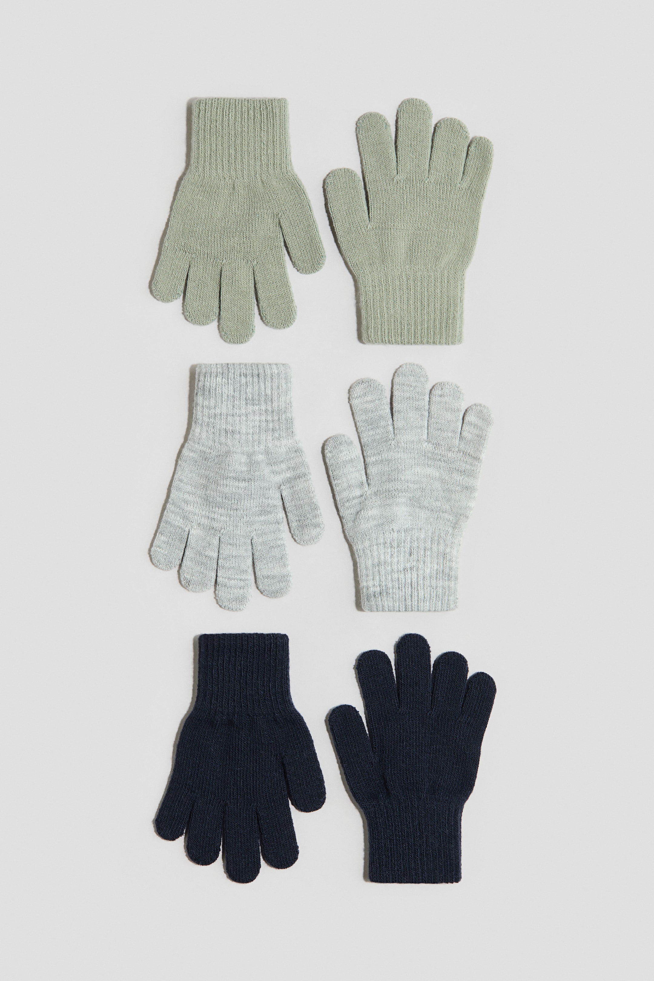 Ver imagen más grande: Los guantes se presentan en tres pares, cada uno confeccionado en un tejido de punto suave y fino con puños acanalados. Se muestran de frente en verde claro, gris jaspeado claro y azul oscuro.