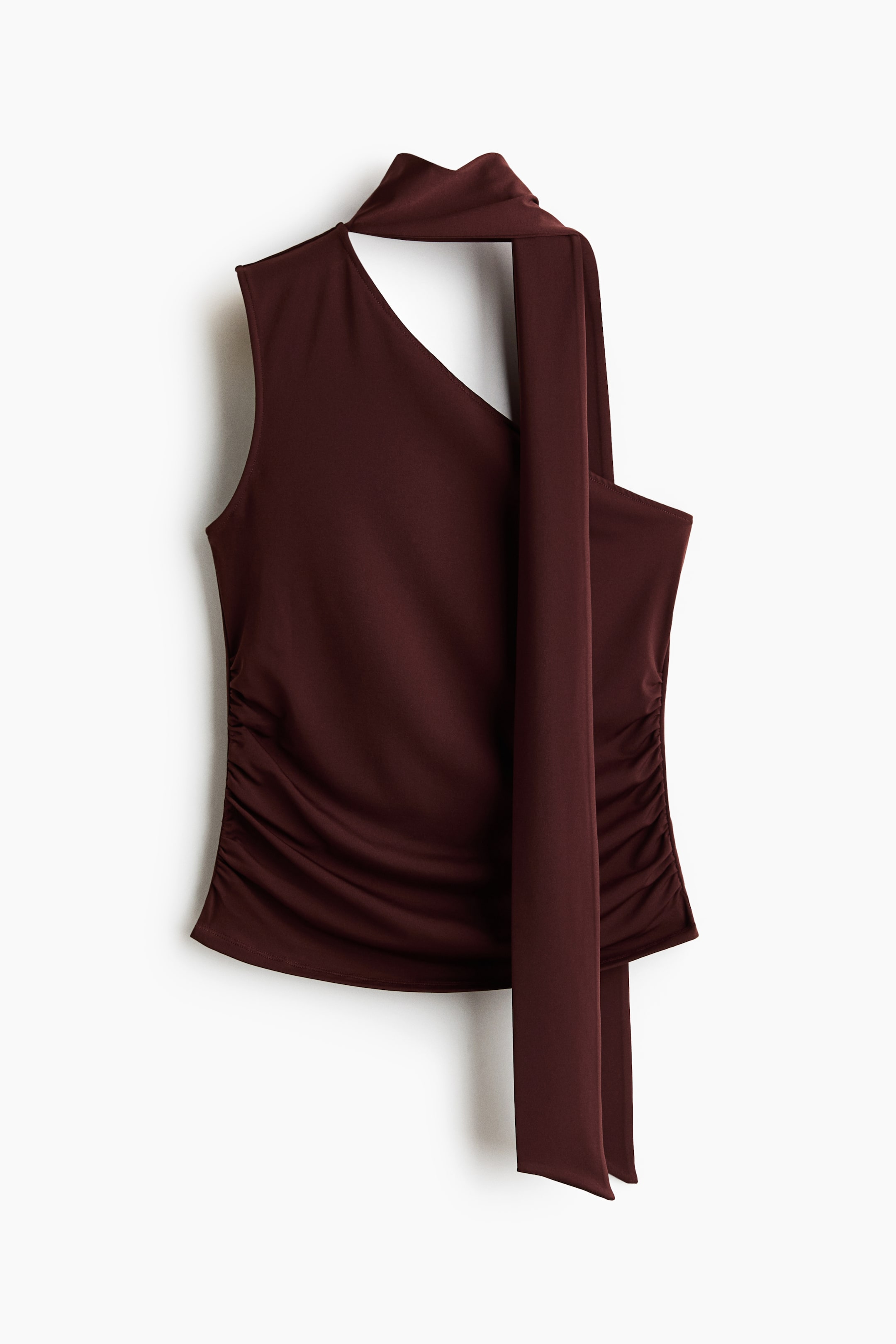 View larger image: A dark red sleeveless top showcasing an asymmetric neckline with one shoulder left bare. A broad strap extends from the other shoulder into a lengthy tie, elegantly wrapping around the neck and cascading down the front. Both side seams exhibit subtle ruching.