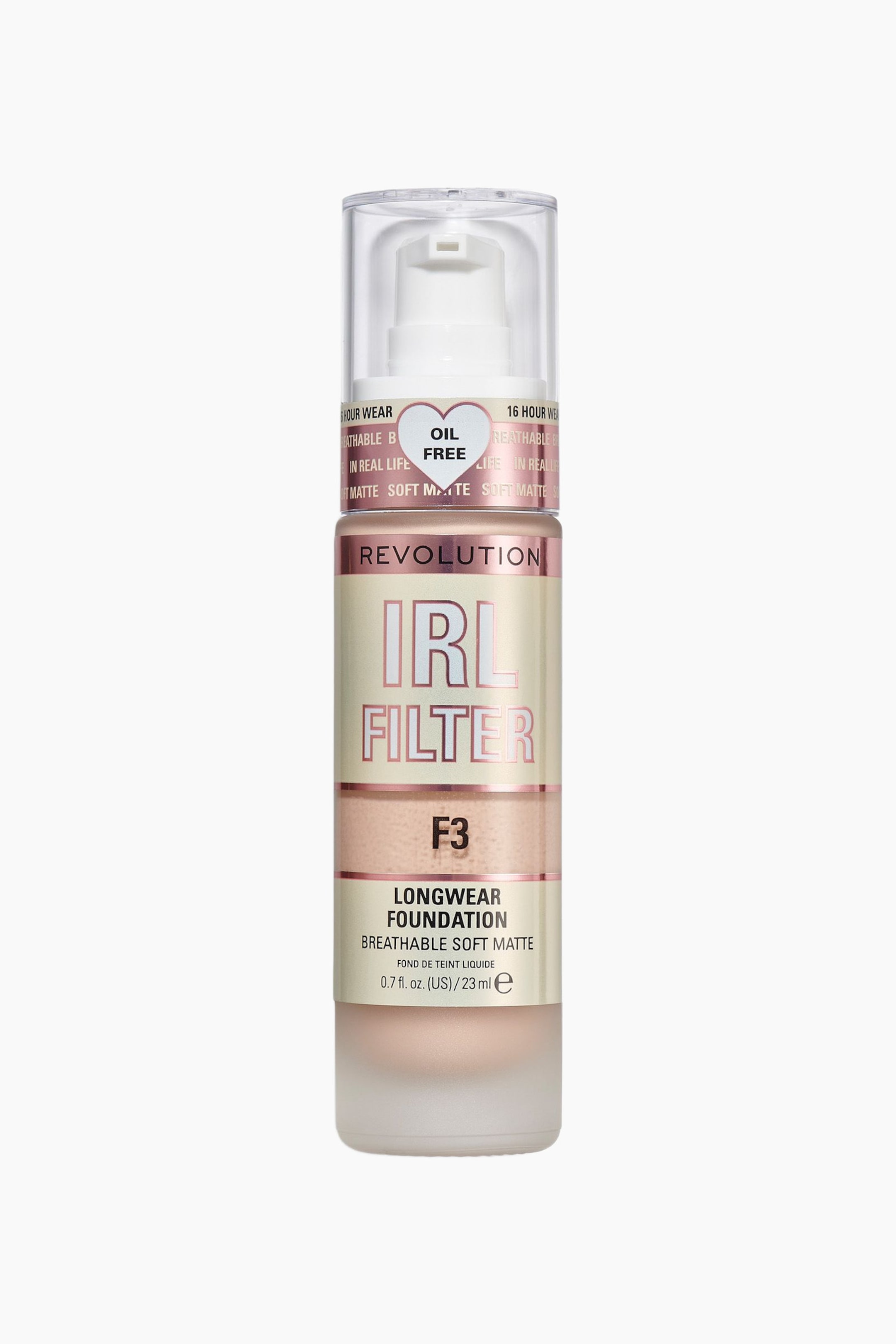 Größeres Bild ansehen: Die Revolution IRL Filter Longwear Foundation steht aufrecht und präsentiert sich in einer mattierten zylindrischen Flasche, gefüllt mit hellbeiger flüssiger Foundation. Sie zeigt eine transparente Kunststoffkappe über einem weißen Pumpspender, einen roségoldfarbenen Metallring sowie ein cremefarbenes Etikett mit metallisch-pinken „IRL FILTER“-Schriftzug und schwarzem „F3“-Text.