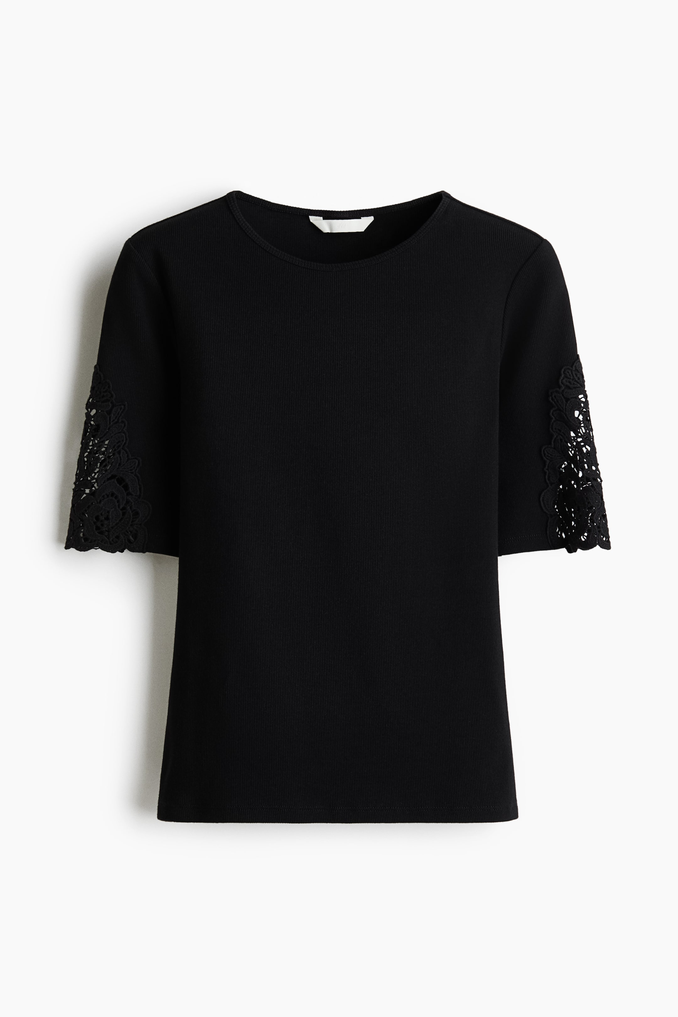 View larger image: A black fitted top crafted from ribbed cotton jersey is displayed from the front, showcasing a round neckline and short sleeves adorned with intricate lace insets.