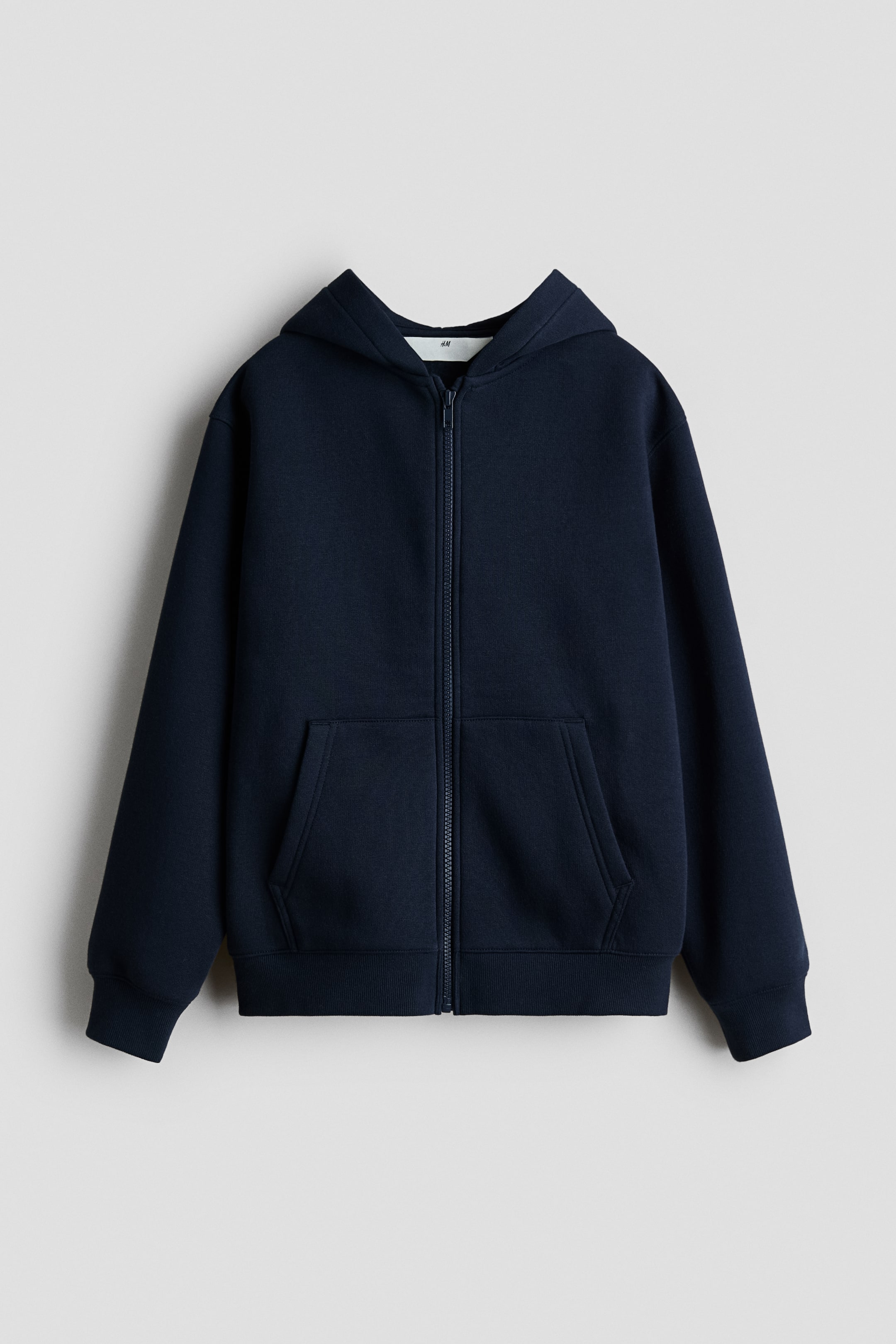 View larger image: A navy blue zip-up hoodie is shown front-facing, featuring a centre front zipper, a split kangaroo pocket, ribbed cuffs, and a ribbed hem, with the hood visible at the back.