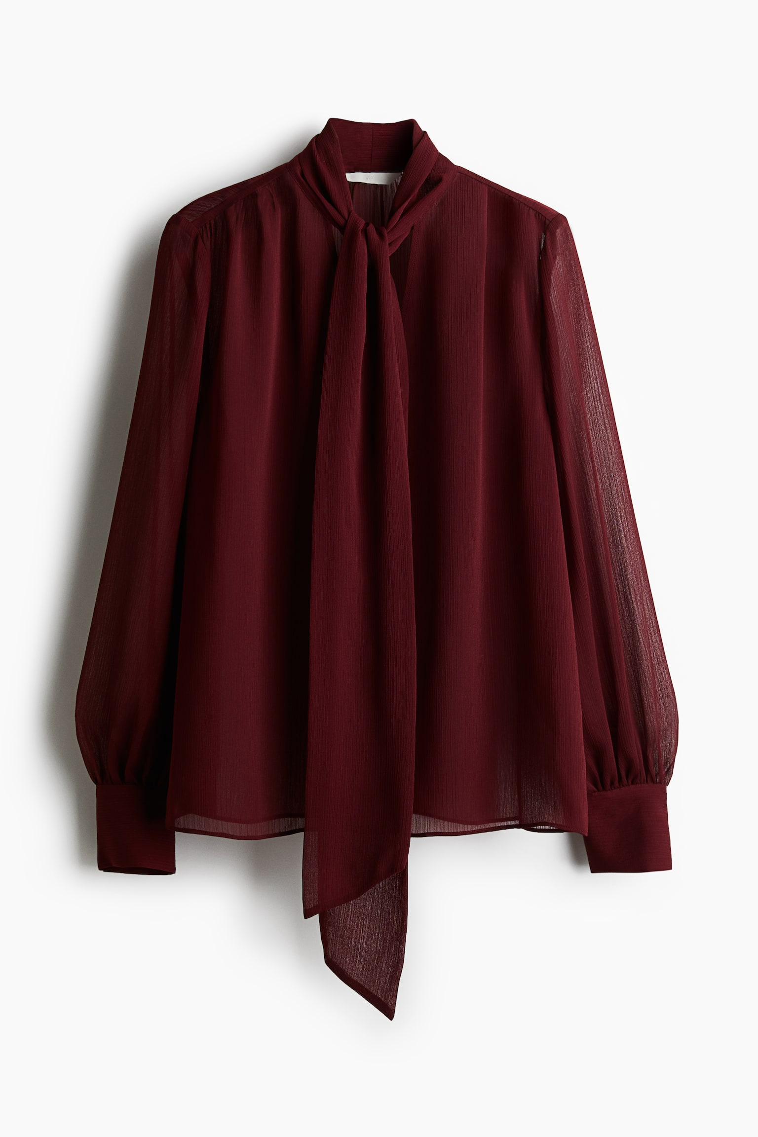 Burgundy H&M Blouse in sheer chiffon with a bow collar and a V-shaped opening at the front. Gathers on the shoulders and long balloon sleeves with buttoned cuffs. Unlined.