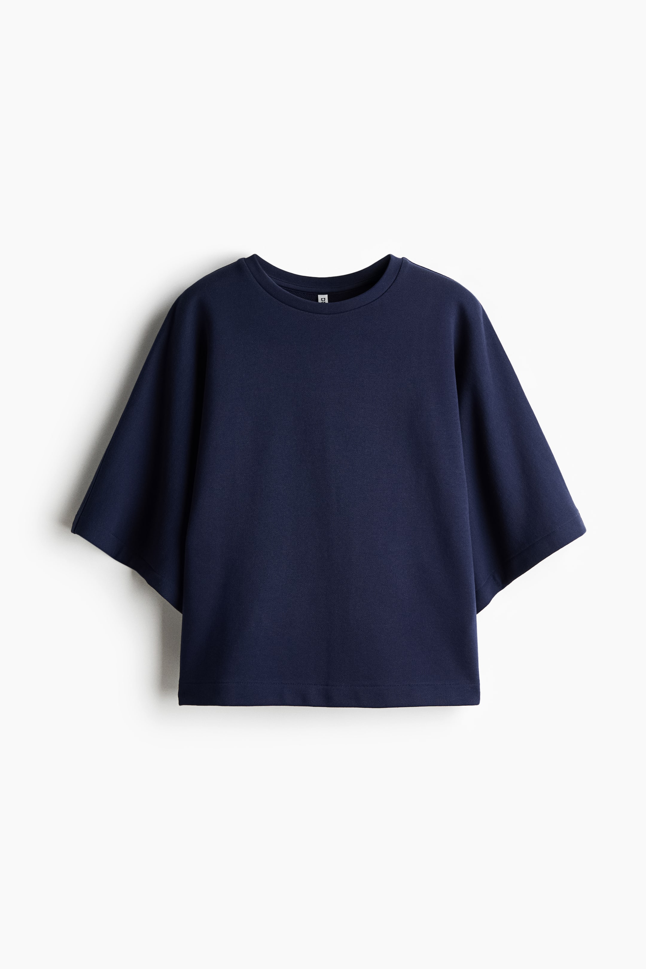 View larger image: This navy blue top is shown from the front. It features a crew neck and wide, short sleeves, and displays a straight hem, creating a relaxed, boxy silhouette.