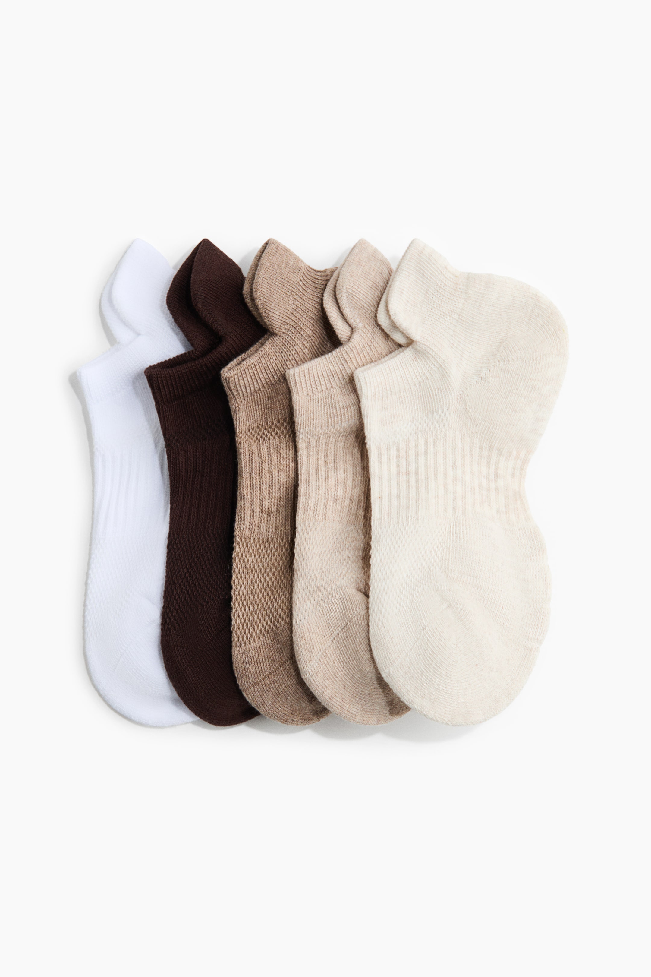 View larger image: Six ankle socks are arranged diagonally, showcasing neutral shades of white, dark brown, and assorted beige hues. Each sock features ribbed cuffs, with some displaying a mesh-like knit on the body while others boast a smoother texture.