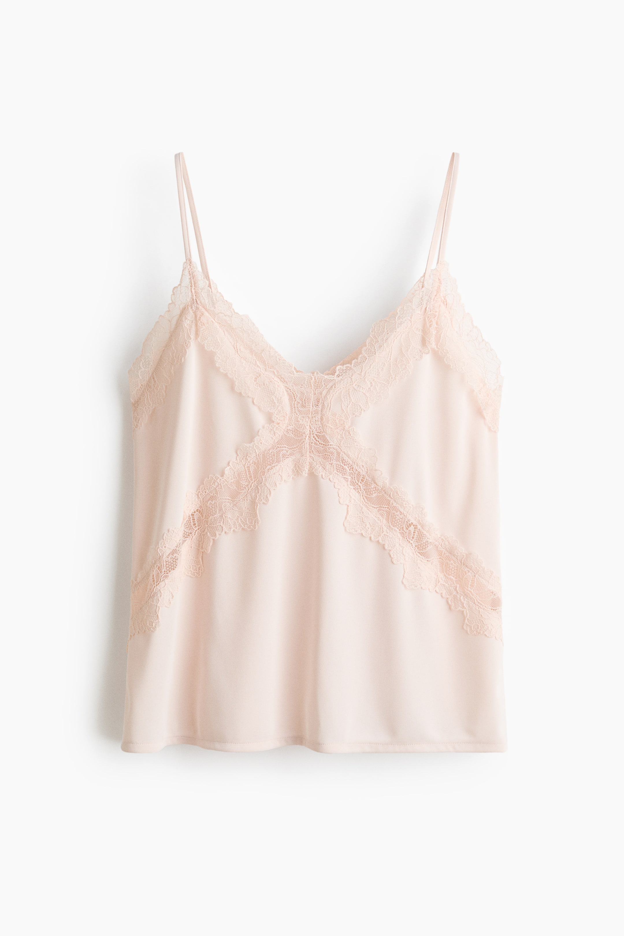 View larger image: A blush pink camisole is shown in a front-facing view. It features a V-neckline with thin spaghetti straps, and intricate lace trim details the neckline, forming a distinct X-shaped pattern across the front bodice.