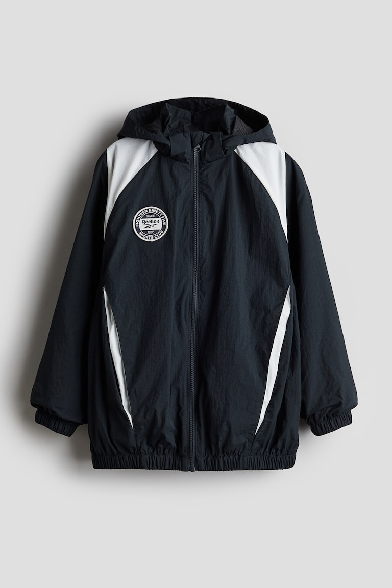 Giacca a vento con motivo Nero/Reebok BAMBINO H&M IT